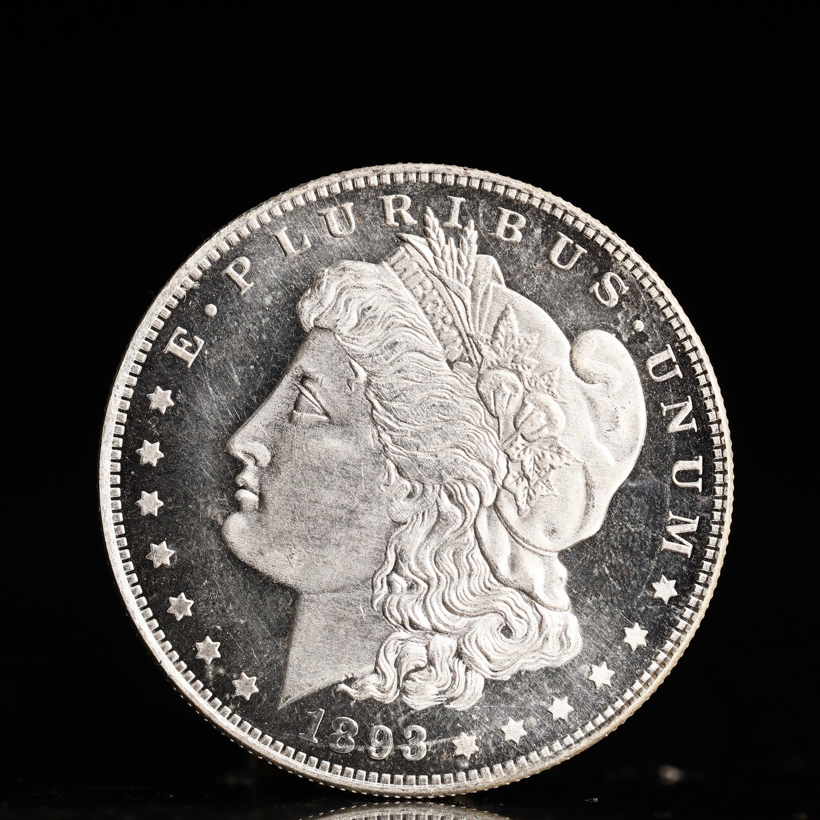 USA Morgan Dollar 1893 Coin: Obv: profile bust with date below and E PLURIBUS UNUM legend and stars around. Rev: eagle with In God we trust above within wreath with UNITED STATES OF AMERICA ONE DOLLAR legend. IN GOD WE TRUST / LI