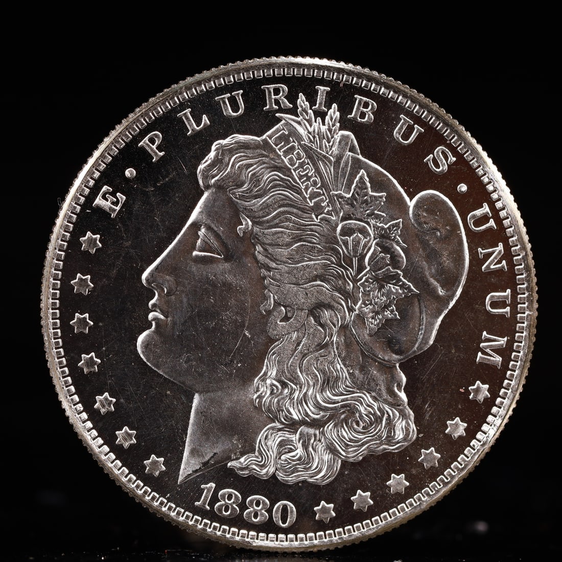 USA Morgan Dollar 1880 Coin: Obv: profile bust with date below and E PLURIBUS UNUM legend and stars around. Rev: eagle with In God we trust above within wreath with UNITED STATES OF AMERICA ONE DOLLAR legend. IN GOD WE TRUST /