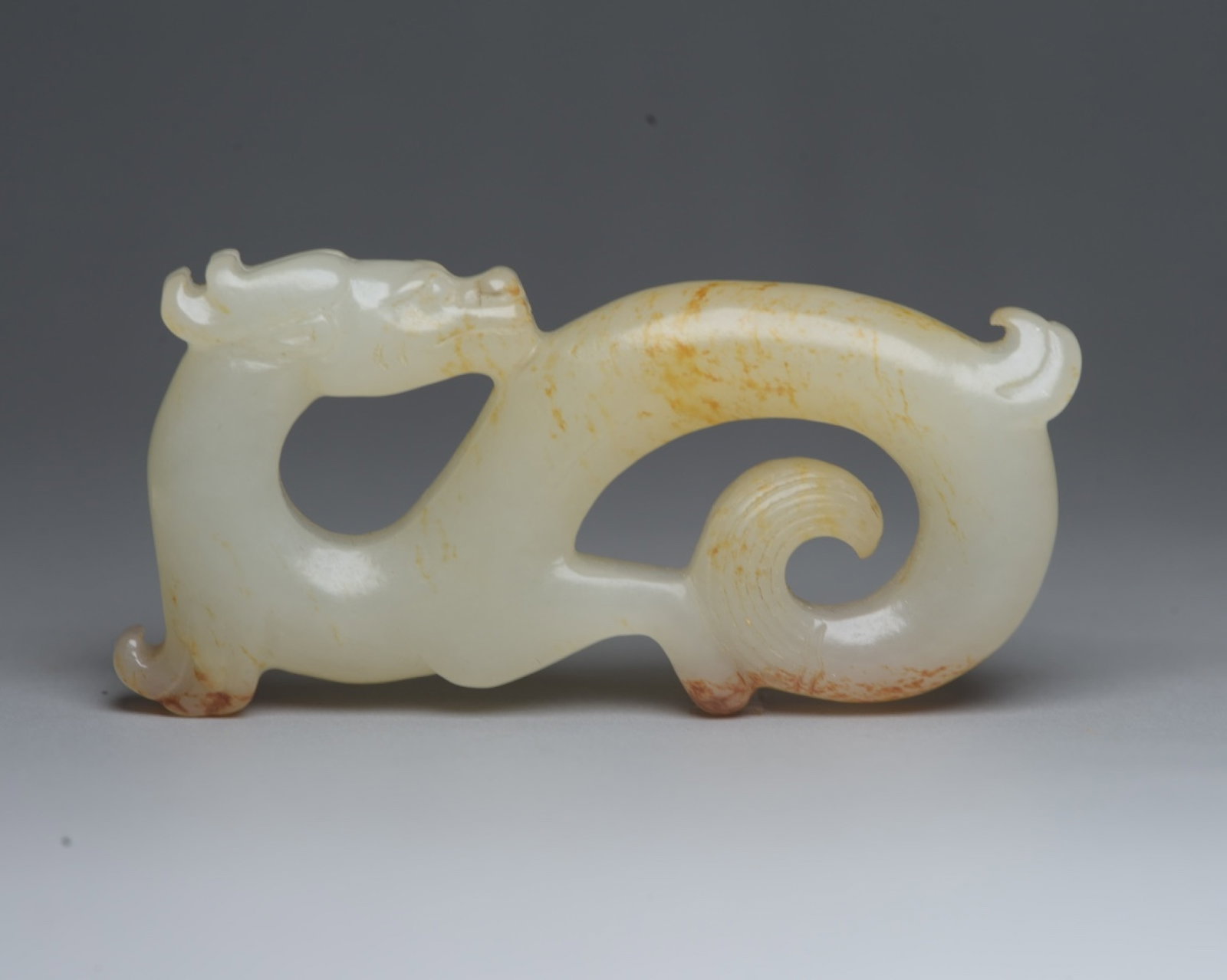 An Exquisite White Jade Dragon Ornament: An Exquisite White Jade Dragon Ornament,Qing Dynasty,China,Size:3inx1.5inx0.4in,Weight:56g 白玉龙摆件,中国清代