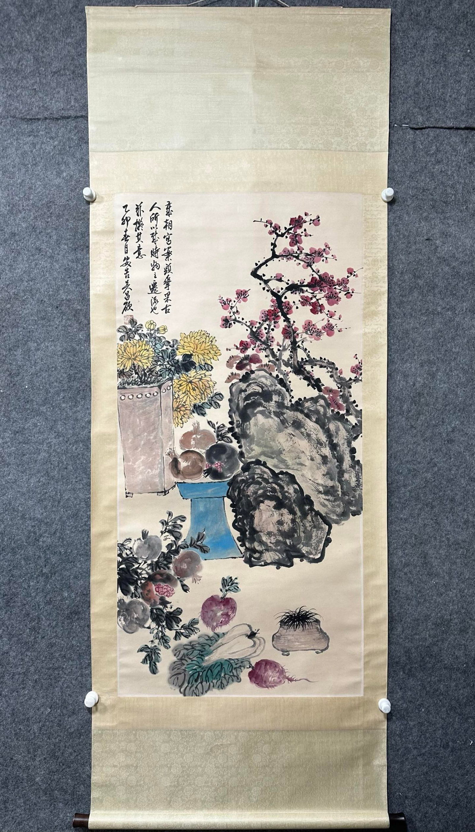 A Chinese Vertical Scroll Ink Painting of Flower and Fruit on Paper: A Chinese Vertical Scroll Ink Painting of Flower and Fruit on Paper,Wu Changshuo,Size:26.8inx53.9in 一幅中国水墨花果画立轴,吴