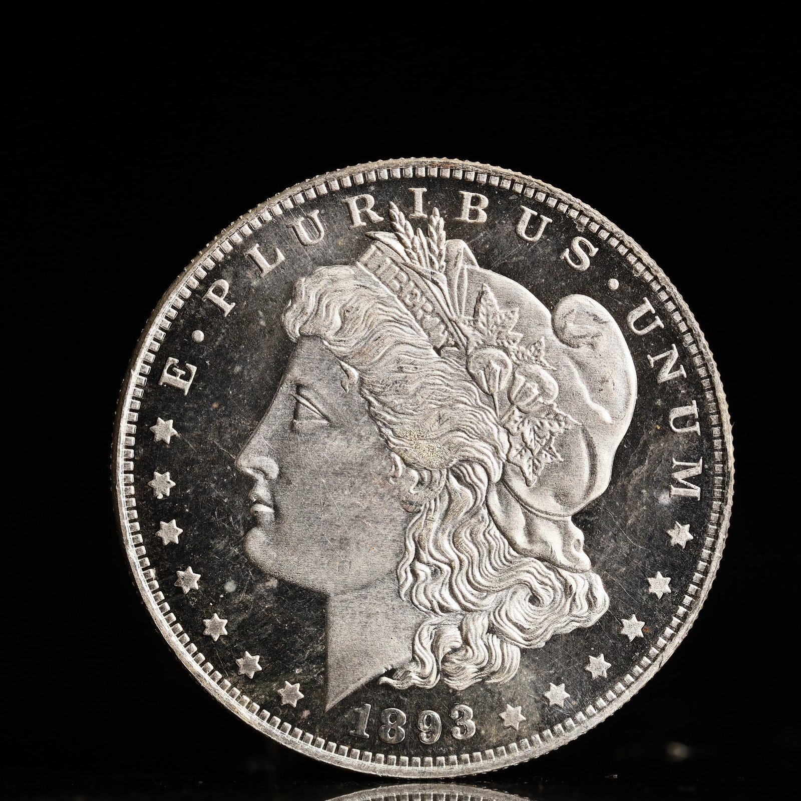 USA Morgan Dollar 1893 Coin: Obv: profile bust with date below and E PLURIBUS UNUM legend and stars around. Rev: eagle with In God we trust above within wreath with UNITED STATES OF AMERICA ONE DOLLAR legend. IN GOD WE TRUST / LI