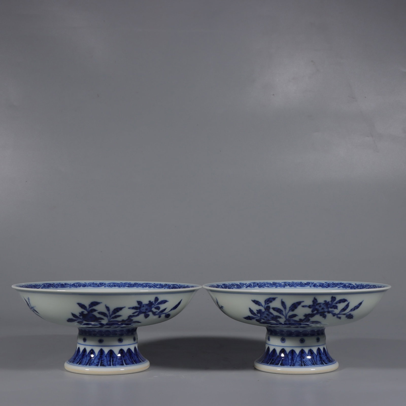 A Pair of Exquisite Blue and White Flower and Fruit Pattern Stem Plates: A Pair of Exquisite Blue and White Flower and Fruit Pattern Stem Plates,Qing Dynasty,China,Qianlong Six-character Mark,Size:3inx6.7in 一对青花花果纹高&#