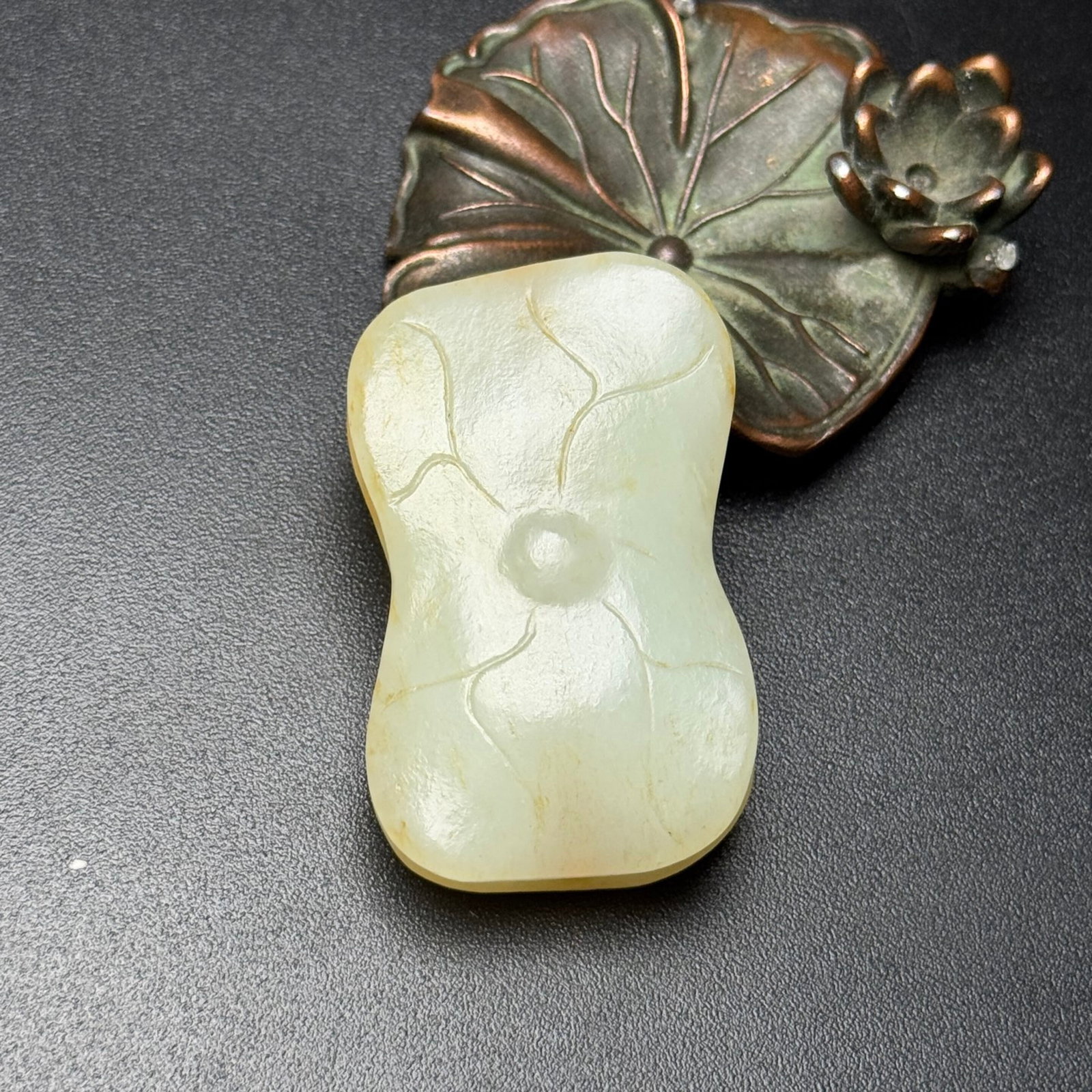 An Exquisite White Jade Lotus Leaf Pendant: An Exquisite White Jade Lotus Leaf Pendant,Qing Dynasty,China,Size:1.2inx1.9inx0.6in,Weight:43g 白玉荷叶挂件,中国清代