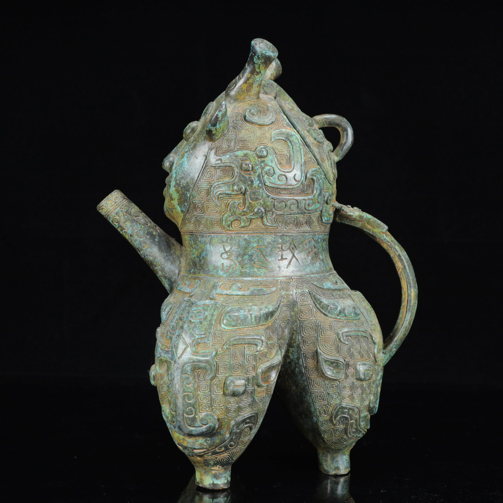 An Archaic Bronze Figure-Face Pattern Tripod Ewer,with Inscription: An Archaic Bronze Figure-Face Pattern Tripod Ewer,with Inscription,the Warring States Period in China,Size:7.9inx6.3inx11in,Weight:2600g