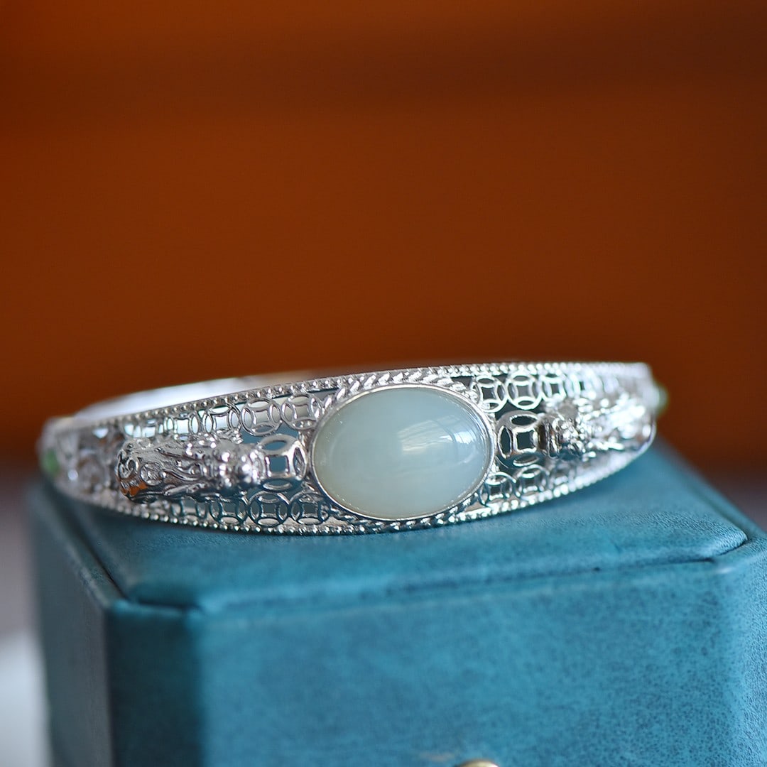 An Exquisite Sterling Silver Inlaid White Jade Wealth-Attracting Creature Pattern Bracelet: An Exquisite Sterling Silver Inlaid White Jade Wealth-Attracting Creature Pattern Bracelet,Size:0.5inx0.7in 纯银镶白玉貔貅纹手镯