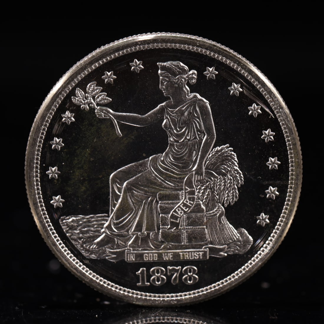 USA Trade Dollar 1878 Coin: American coin. Obverse: Liberty seated on a pedestal facing the sea to the left holding olive branches surrounded by 13 stars. IN GOD WE TRUST / LIBERTY / 1878. Reverse: An eagle holding branches with
