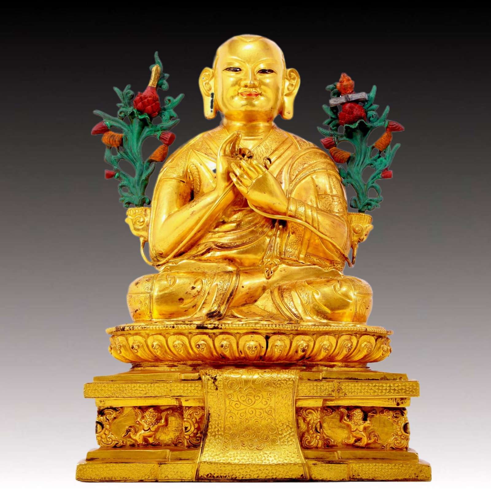 A solemn gilt bronze statue of the Guru: A solemn gilt bronze statue of the Master, Qianlong seven-character mark, Qing Dynasty, China, The image of the guru is shown in a sitting posture. The attire is a traditional monk's robe, and the fac