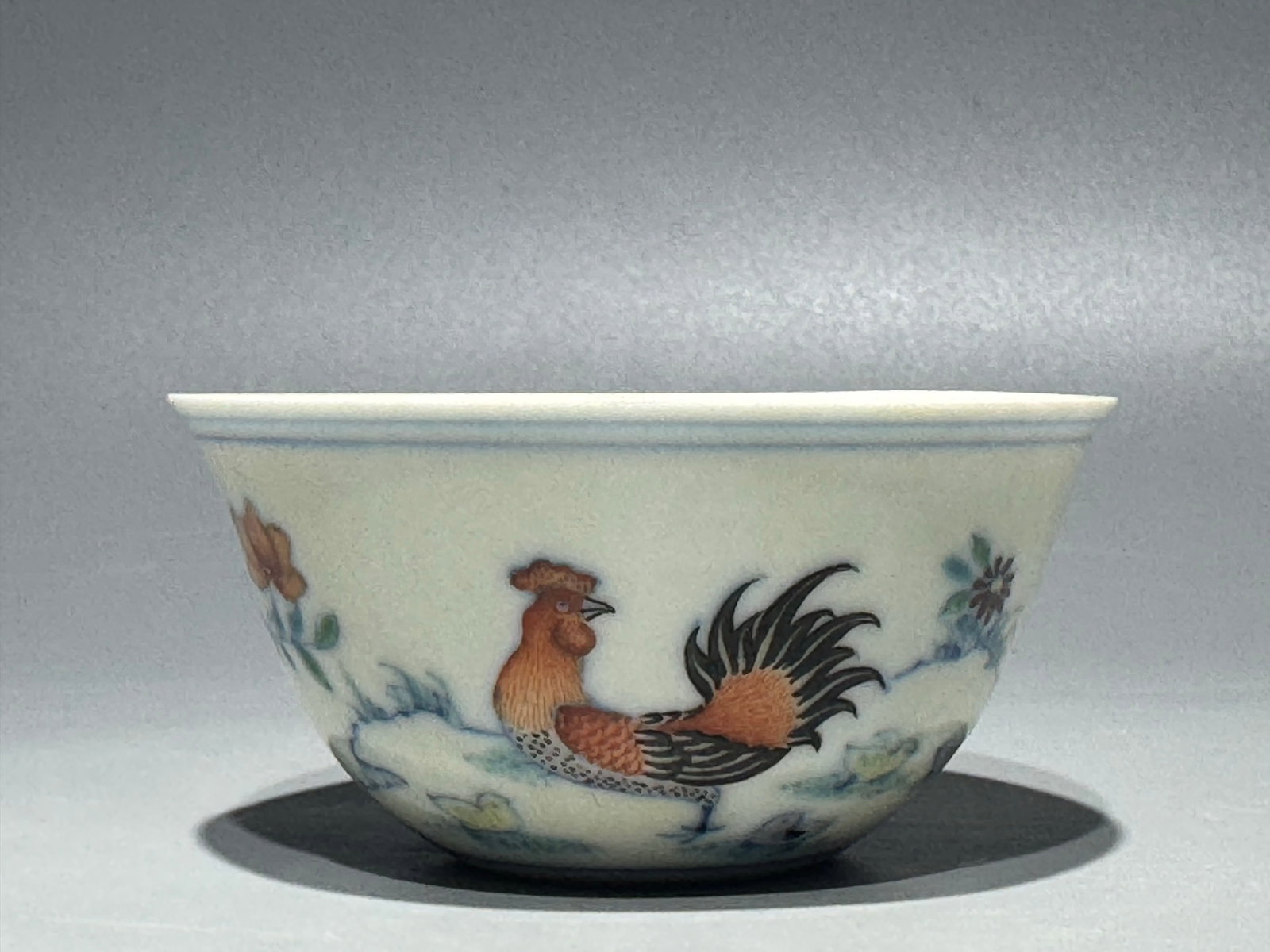 An Exquisite Doucai Flower and Rooster Pattern Cup: An Exquisite Doucai Flower and Rooster Pattern Cup,Ming Dynasty,China,Chenghua Four-character Mark,Size:1.3inx2.7in