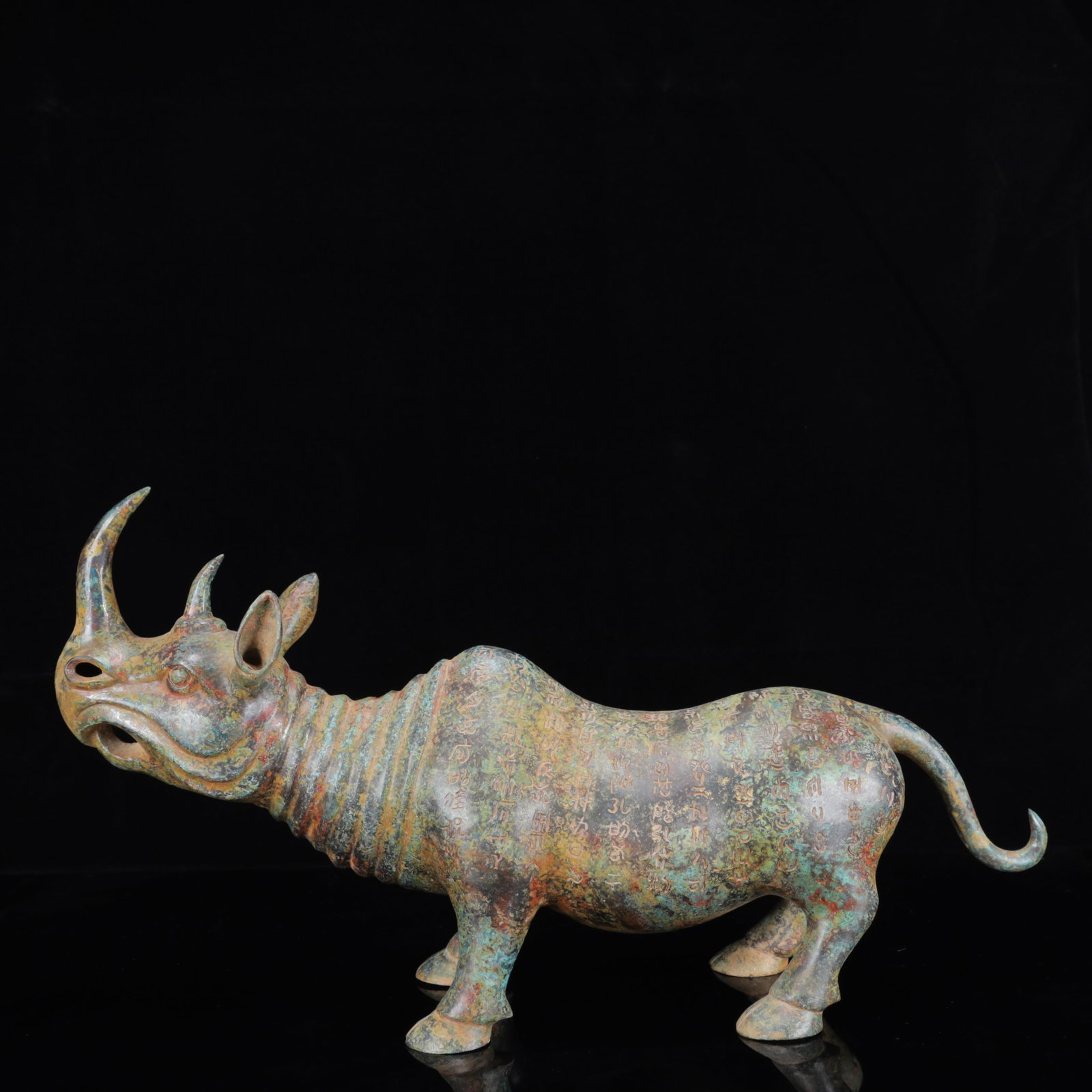 A Huge Bronze Inscription Rhinoceros Ornament: A Huge Bronze Inscription Rhinoceros Ornament,the Warring States Period in China,Size:20.5inx5.1inx11in,Weight:3150g 青铜铭文犀牛摆件,中国&#
