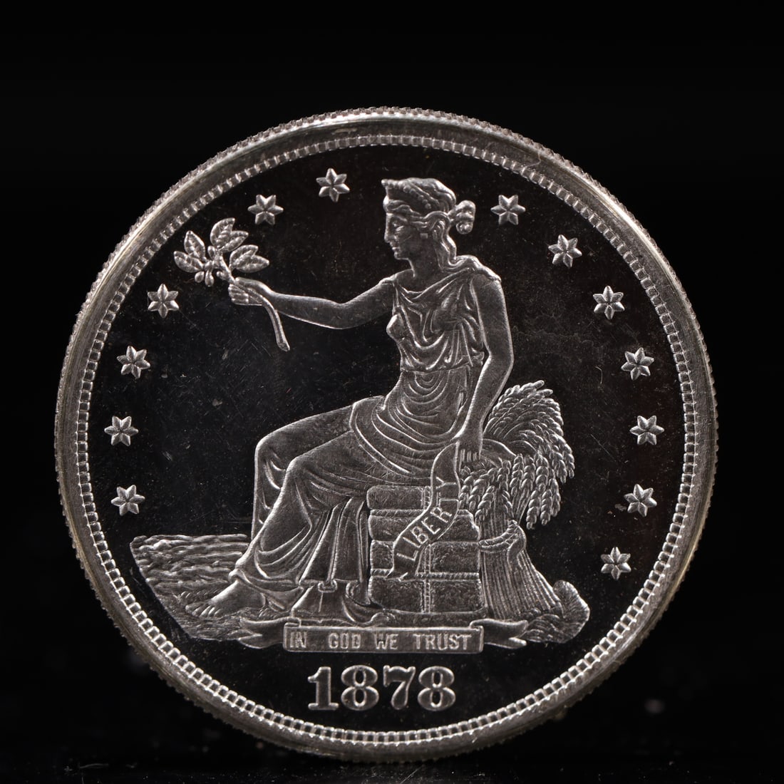 USA Trade Dollar 1878 Coin: American coin. Obverse: Liberty seated on a pedestal facing the sea to the left holding olive branches surrounded by 13 stars. IN GOD WE TRUST / LIBERTY / 1878. Reverse: An eagle holding branches with