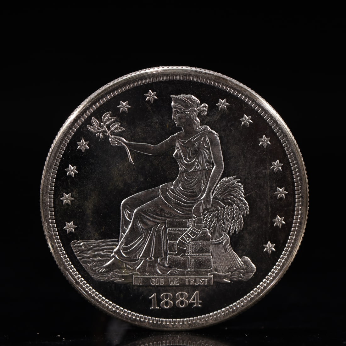 USA Trade Dollar 1884 Coin: American coin. Obverse: Liberty seated on a pedestal facing the sea to the left holding olive branches surrounded by 13 stars. IN GOD WE TRUST / LIBERTY / 1884. Reverse: An eagle holding branches with