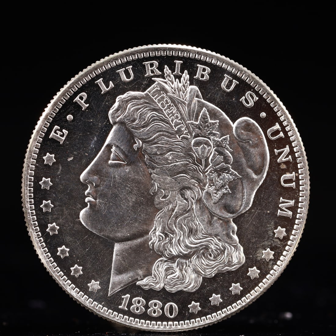 USA Morgan Dollar 1880 Coin: Obv: profile bust with date below and E PLURIBUS UNUM legend and stars around. Rev: eagle with In God we trust above within wreath with UNITED STATES OF AMERICA ONE DOLLAR legend. IN GOD WE TRUST / LI