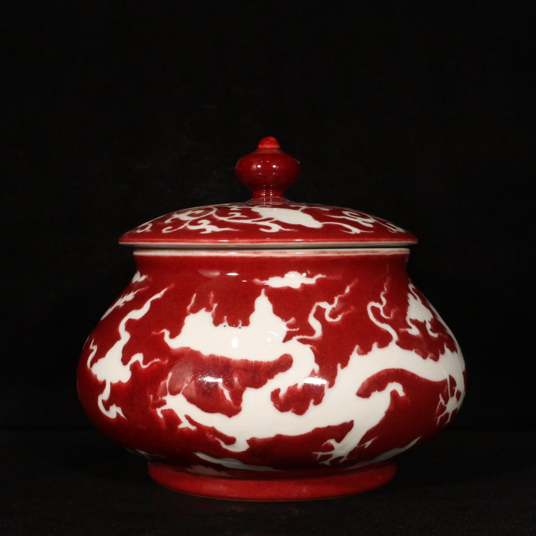 An Exquisite Ji Red Glazed Auspicious Cloud and Dragon Pattern Jar with Cover: An Exquisite Ji Red Glazed Auspicious Cloud and Dragon Pattern Jar with Cover,Ming Dynasty,China,Xuande Six-character Mark,Size:7.3inx8.5in 霁红釉祥云龙纹
