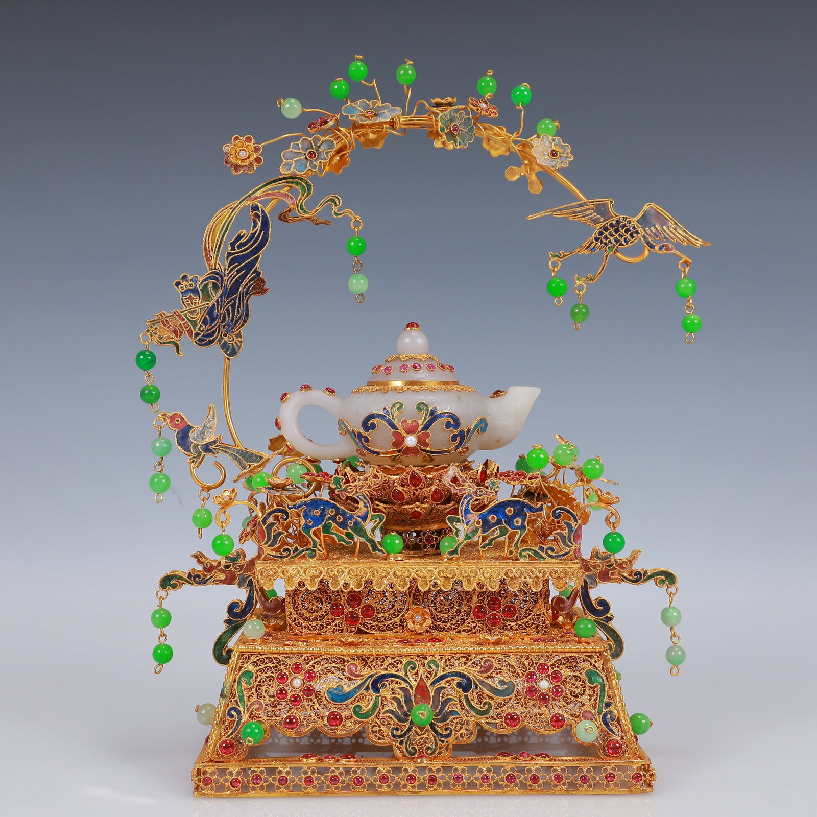 An Exquisite Filigree and Gilding Inlaid White Jade Teapot,Inlaid Gems: An Exquisite Filigree and Gilding Inlaid White Jade Teapot,Inlaid Gems,Qing Dynasty, China,Qianlong Four-Character Mark,Size:6.3inx4.7inx10.6in,Weight:850g 花丝鎏金嵌