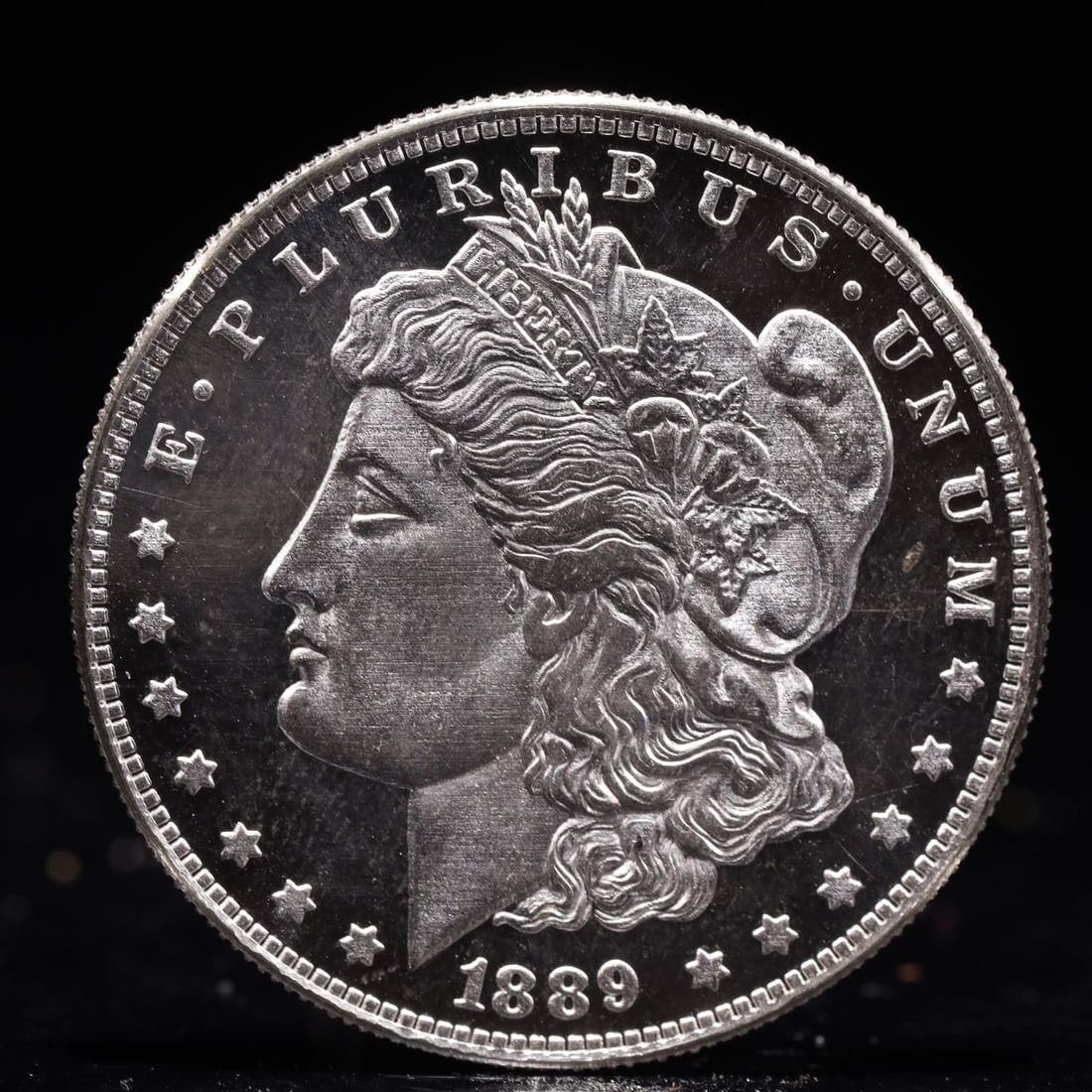 USA Morgan Dollar 1889 Coin: Obv: profile bust with date below and E PLURIBUS UNUM legend and stars around. Rev: eagle with In God we trust above within wreath with UNITED STATES OF AMERICA ONE DOLLAR legend. IN GOD WE TRUST / LI