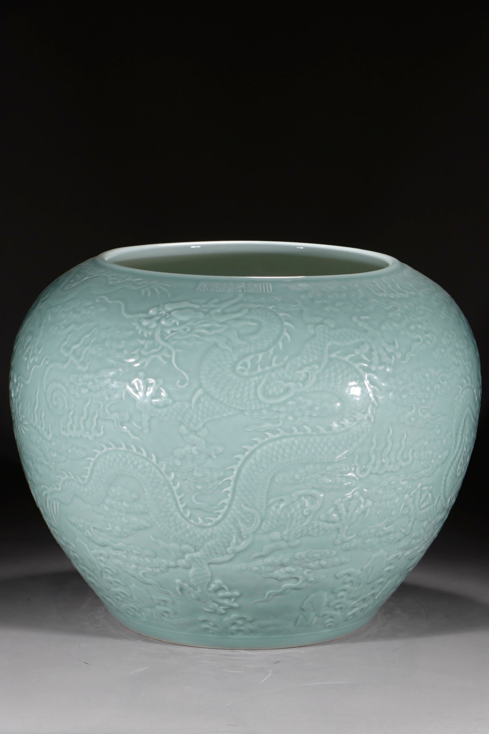 A Huge Celadon Glazed Auspicious Cloud and Dragon Pattern Vat: A Huge Celadon Glazed Auspicious Cloud and Dragon Pattern Vat,Qing Dynasty,China,Qianlong Six-character Mark,Size:17.2inx22.4in 粉青釉祥云龙纹缸,中