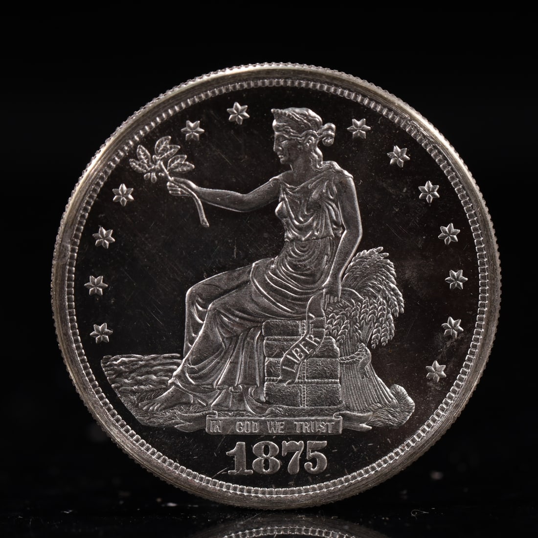 USA Trade Dollar 1875 Coin: American coin. Obverse: Liberty seated on a pedestal facing the sea to the left holding olive branches surrounded by 13 stars. IN GOD WE TRUST / LIBERTY / 1875. Reverse: An eagle holding branches with