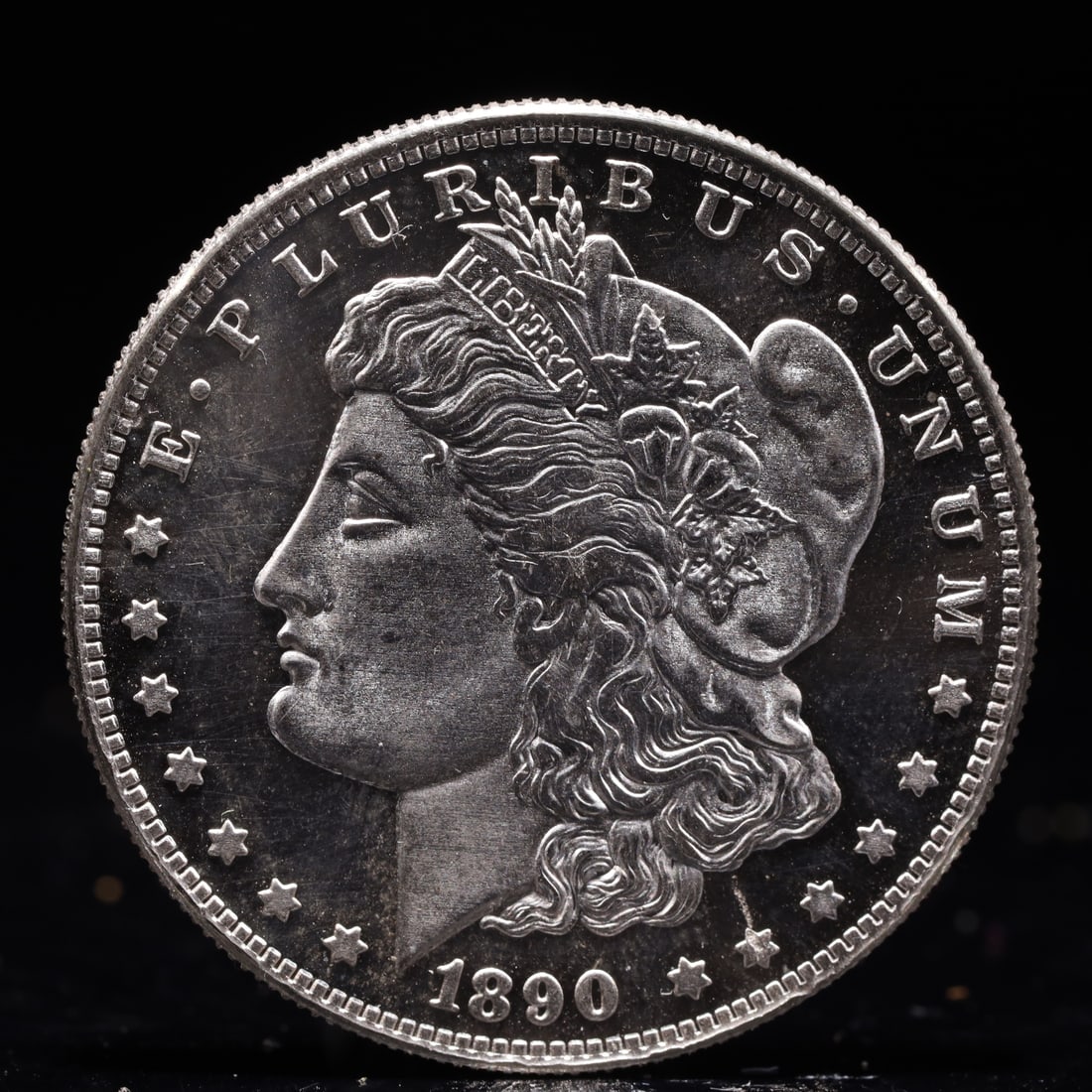 USA Morgan Dollar 1890 Coin: Obv: profile bust with date below and E PLURIBUS UNUM legend and stars around. Rev: eagle with In God we trust above within wreath with UNITED STATES OF AMERICA ONE DOLLAR legend. IN GOD WE TRUST / LI
