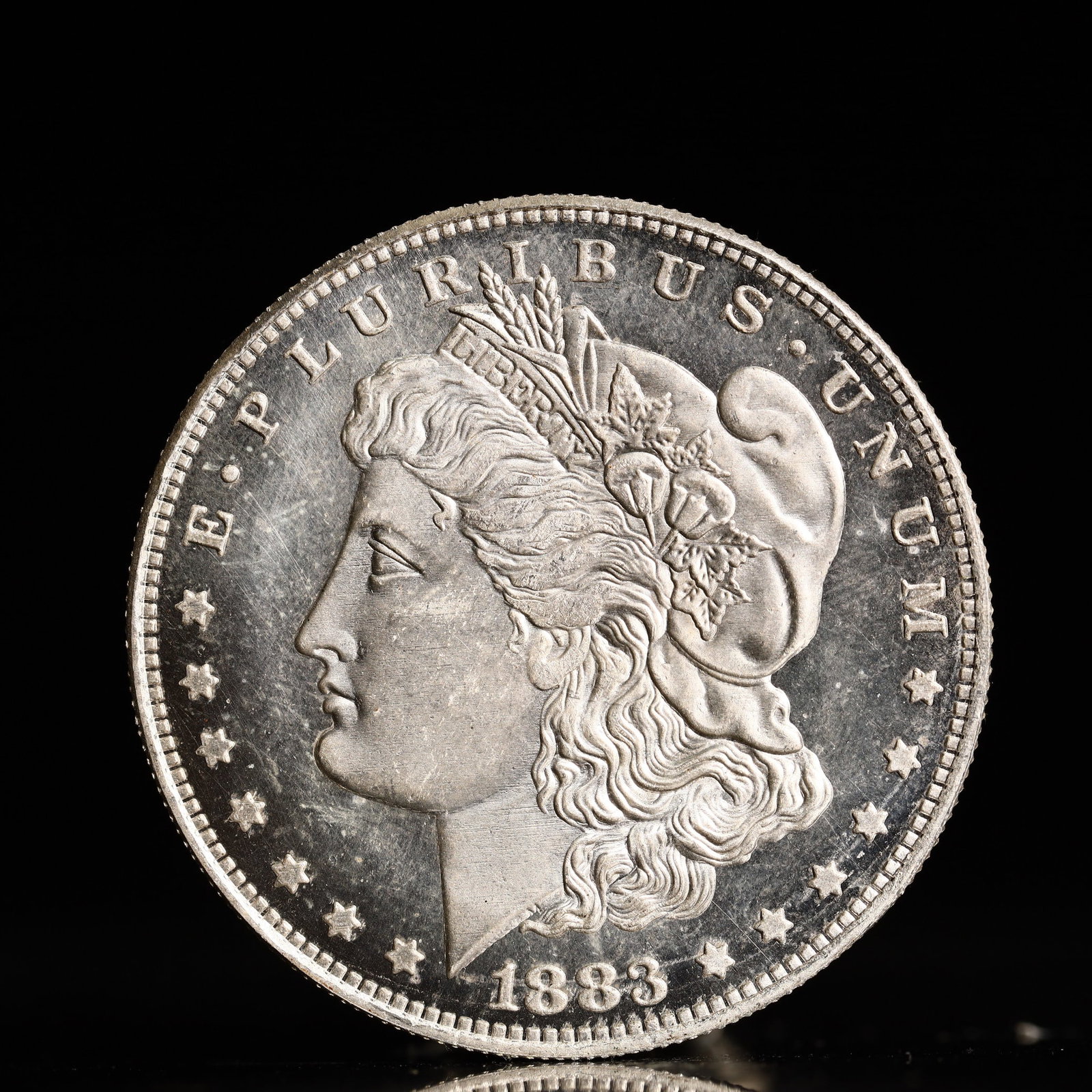 USA Morgan Dollar 1883 Coin: Obv: profile bust with date below and E PLURIBUS UNUM legend and stars around. Rev: eagle with In God we trust above within wreath with UNITED STATES OF AMERICA ONE DOLLAR legend. IN GOD WE TRUST / LI
