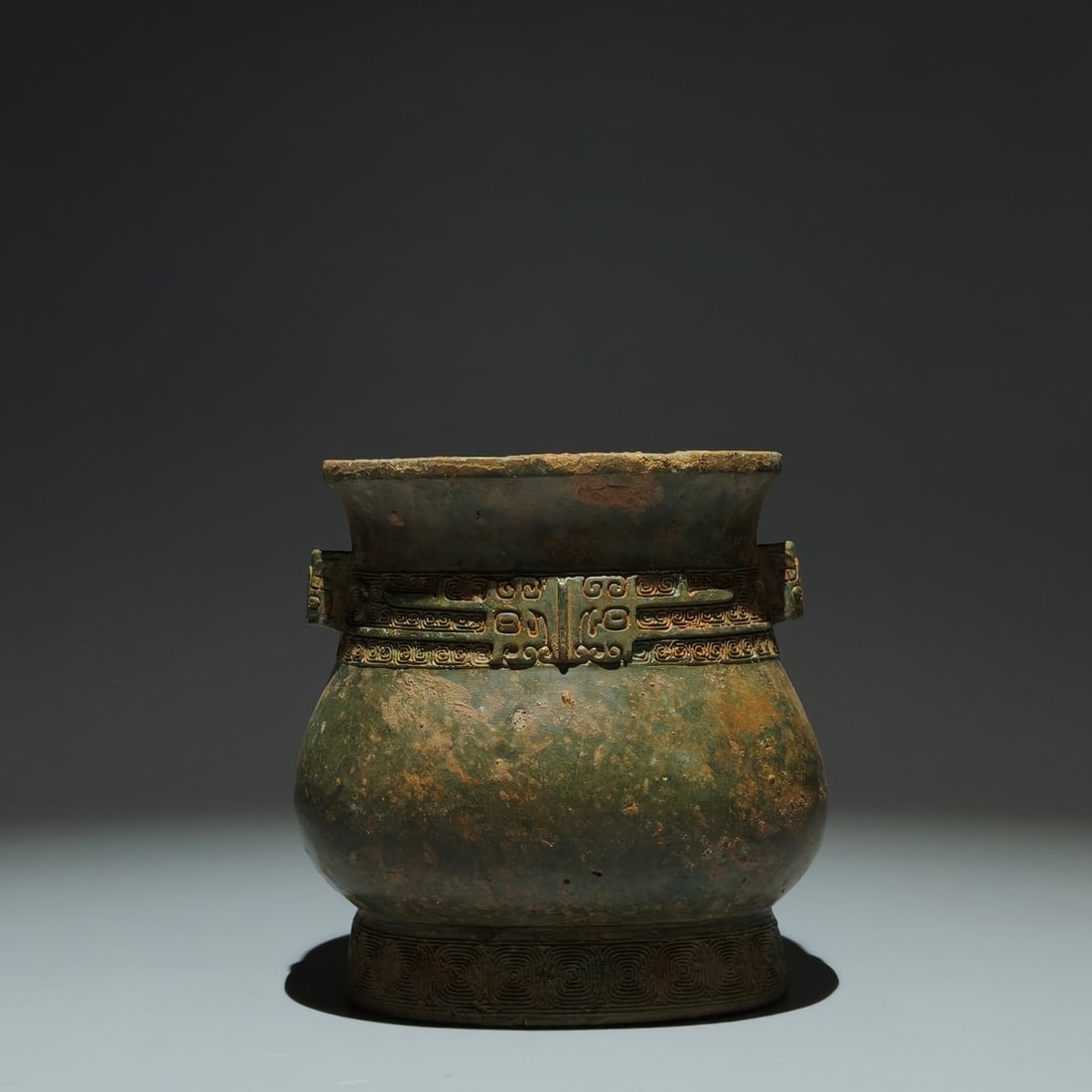 An Archaic Bronze Beast-Face Pattern Double-Ears ritual vessel: An Archaic Bronze Beast-Face Pattern Double-Ears ritual vessel,Shang Dynasty,China,Size:5.3inx5.1inx3.5in 青铜兽面纹双耳礼器,中国Ú