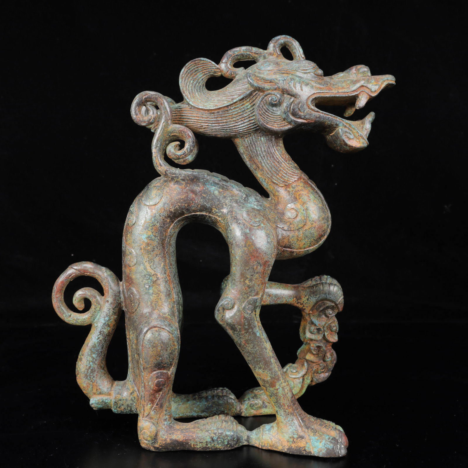 An Archaic Bronze Dragon Ornament: An Archaic Bronze Dragon Ornament,The Warring States period in China,Size:9.1inx4.3inx12.2in,Weight:4050g 青铜龙摆件,中国战国时期