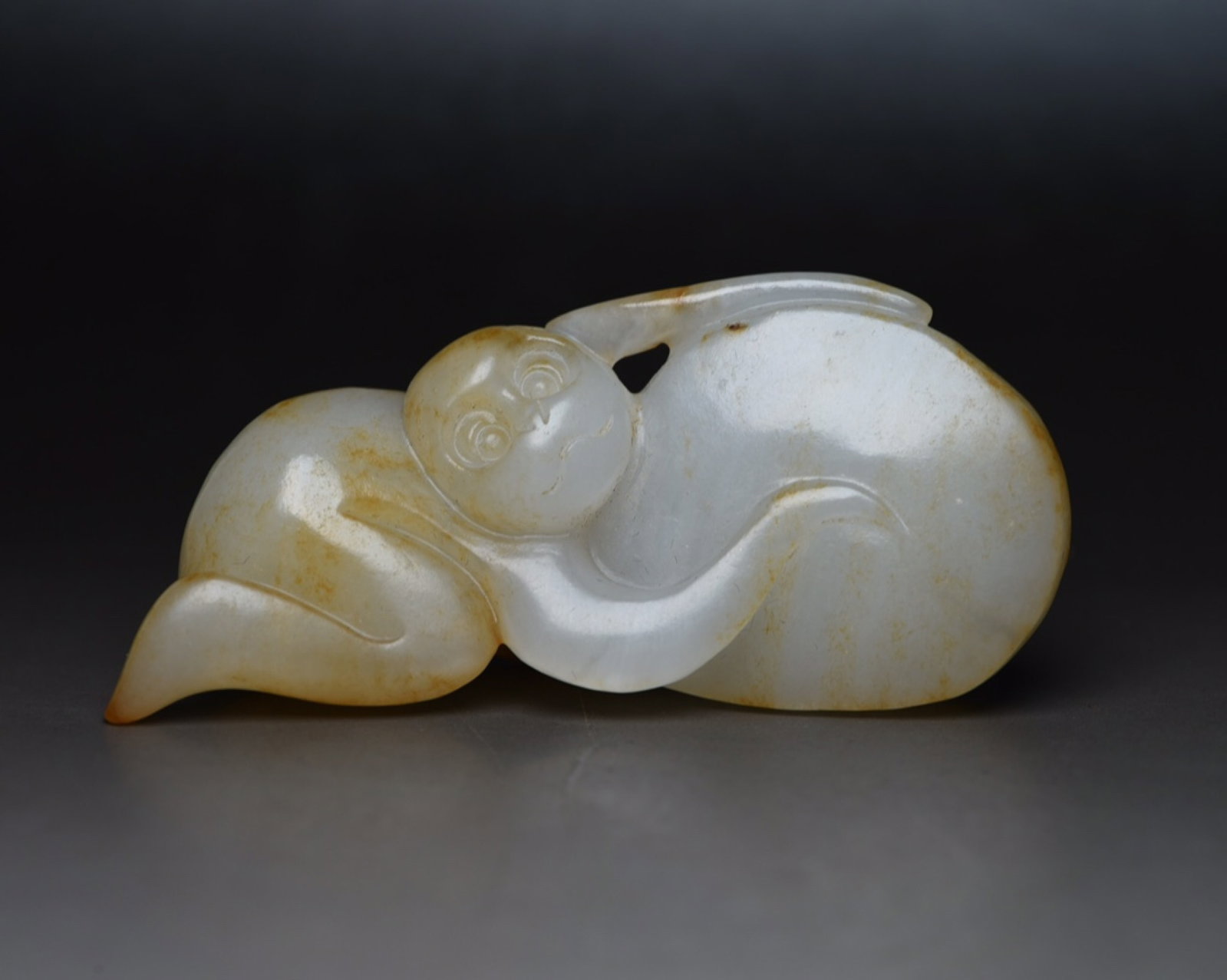 An Exquisite White Jade Monkey Ornament: An Exquisite White Jade Monkey Ornament,Qing Dynasty,China,Size:3inx1.4inx0.9in,Weight:63g 白玉猴子摆件,中国清代