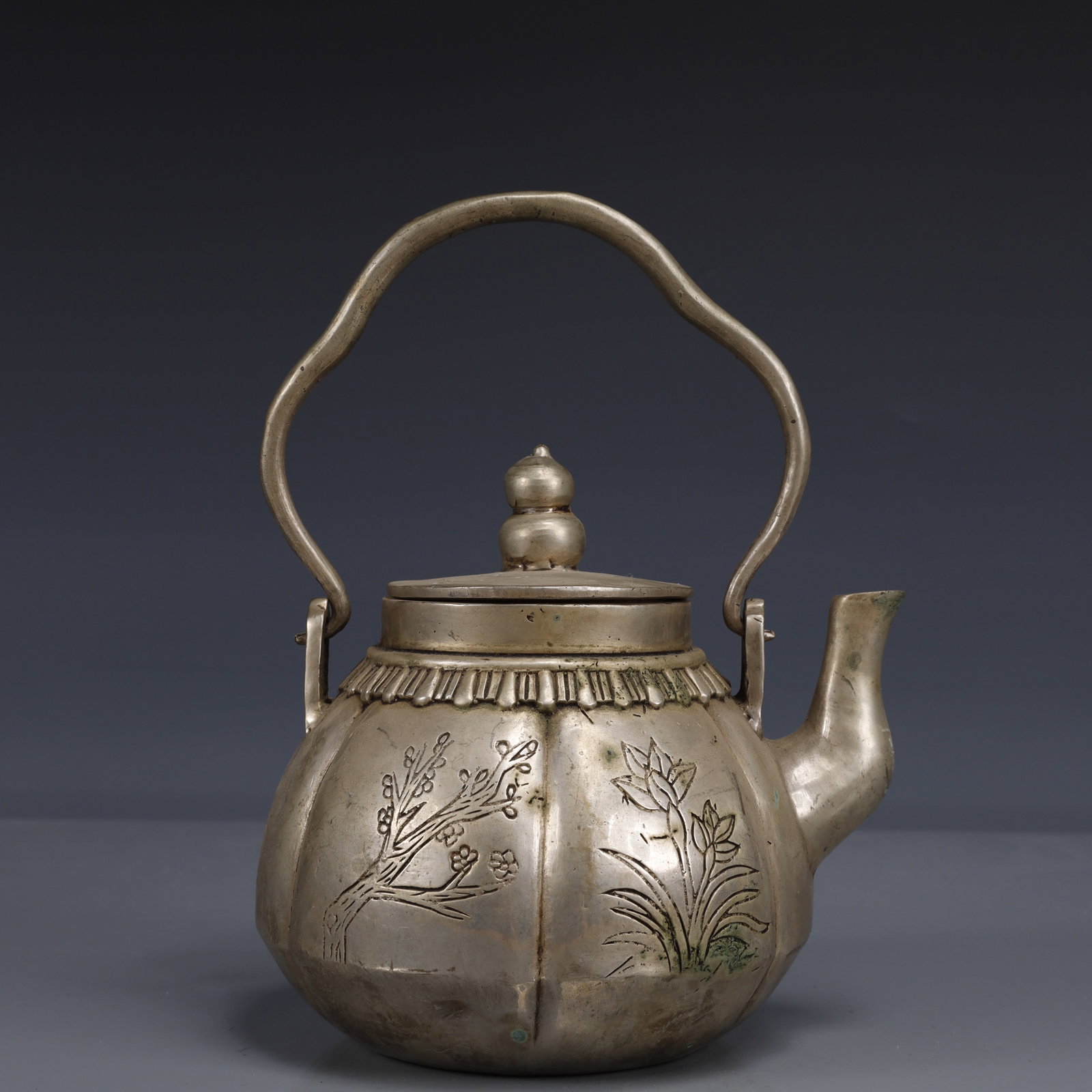 An Exquisite Silver-Plated Bronze Plum Blossom,Orchid Bamboo and Chrysanthemum Pattern Ewer: An Exquisite Silver-Plated Bronze Plum Blossom,Orchid Bamboo and Chrysanthemum Pattern Ewer,Qing Dynasty, China,Qianlong Four-character Mark,Size:5.9inx5.1inx7.9in,Weight:1000g