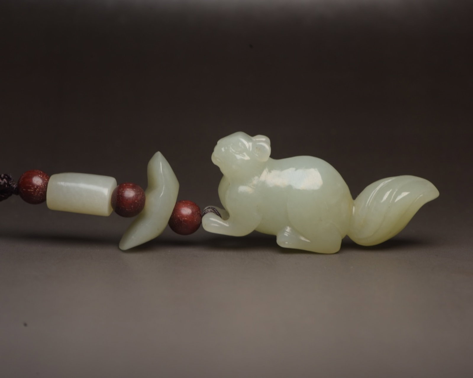 An Exquisite White Jade Squirrel Pendant: An Exquisite White Jade Squirrel Pendant,Qing Dynasty,China,Size:3.6inx0.9inx0.5in,Weight:33g 白玉松鼠挂件,中国清代