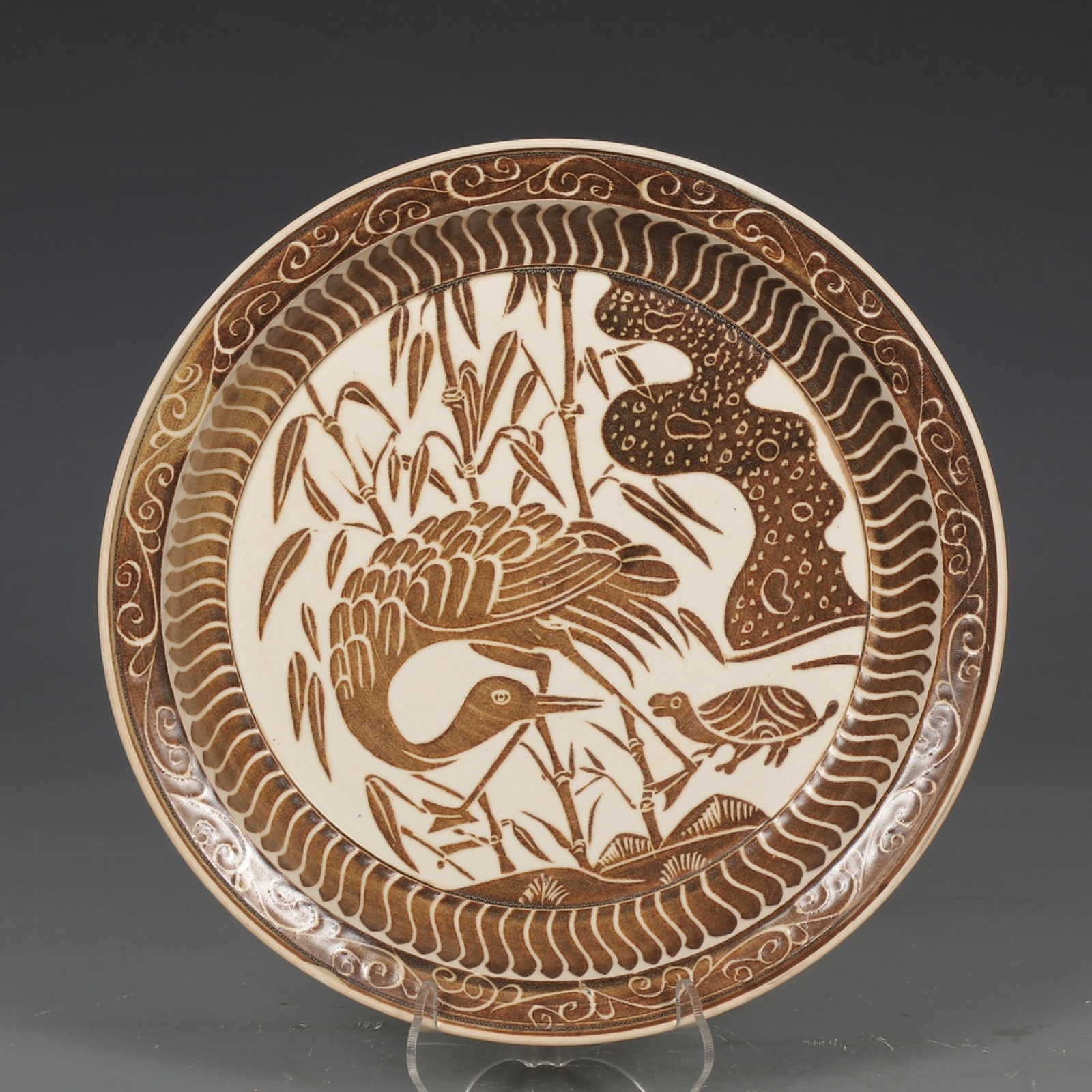 An Exquisite Ding yao Brown Glazed Crane Pattern Plate: An Exquisite Ding yao Brown Glazed Crane Pattern Plate,Song Dynasty,China,Size:1.6inx9.6in 定窑褐彩鹤纹盘,中国宋代
