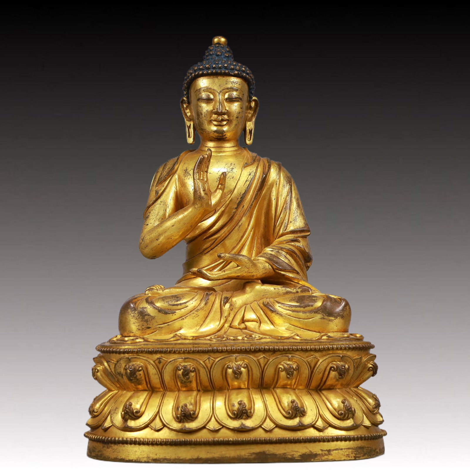 A Solemn Gilt Bronze Statue of Sakyamuni: A Solemn Gilt Bronze Statue of Sakyamuni, Ming Dynasty, China, Xuande Six-character Mark, Size:7.9inx7.1inx13.4in, Weight:5650g 铜鎏金如来像,中国明
