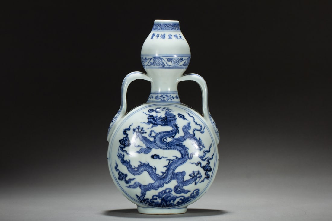 An Exquisite Blue and White Auspicious Cloud and Dragon Pattern Double-Ears Vase: An Exquisite Blue and White Auspicious Cloud and Dragon Pattern Double-Ears Vase,Ming Dynasty,China,Xuande Six-character Mark,Size:6.1inx4.3inx10.8in,Weight:1350g