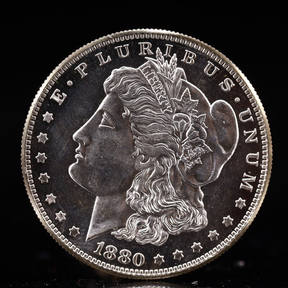 USA Morgan Dollar 1880 Coin: Obv: profile bust with date below and E PLURIBUS UNUM legend and stars around. Rev: eagle with In God we trust above within wreath with UNITED STATES OF AMERICA ONE DOLLAR legend. IN GOD WE TRUST /