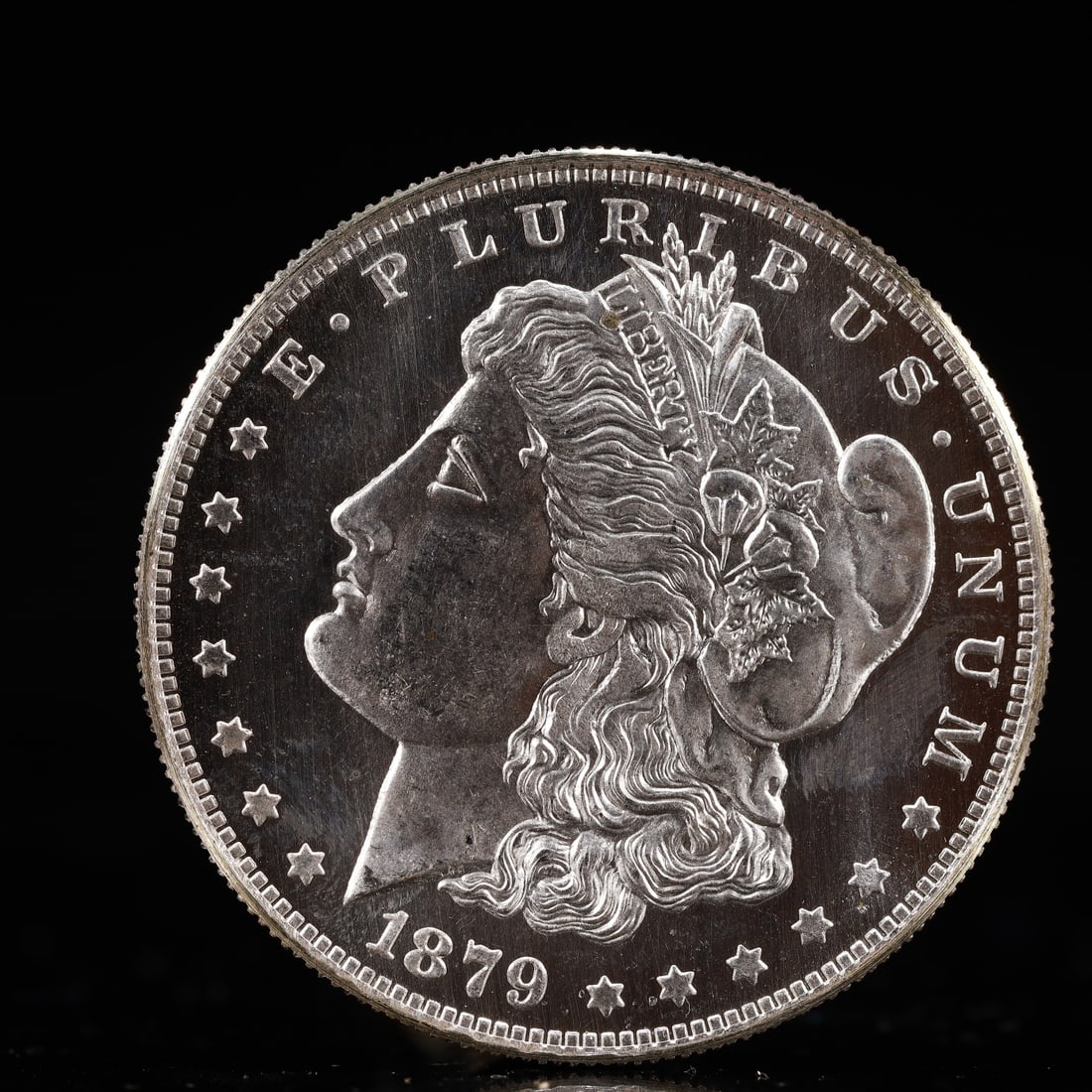 USA Morgan Dollar 1879 Coin: Obv: profile bust with date below and E PLURIBUS UNUM legend and stars around. Rev: eagle with In God we trust above within wreath with UNITED STATES OF AMERICA ONE DOLLAR legend. IN GOD WE TRUST / LI