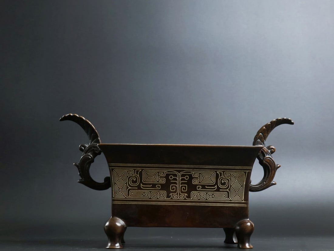 An Exquisite Bronze Inlaid Silver Flower Pattern Double-Ears and Four-legs Censer: An Exquisite Bronze Inlaid Silver Flower Pattern Double-Ears and Four-legs Censer,Qing Dynasty, China, With Mark,Size:4.9inx5.9inx3.9in,Weight:1930g 铜嵌银花卉纹