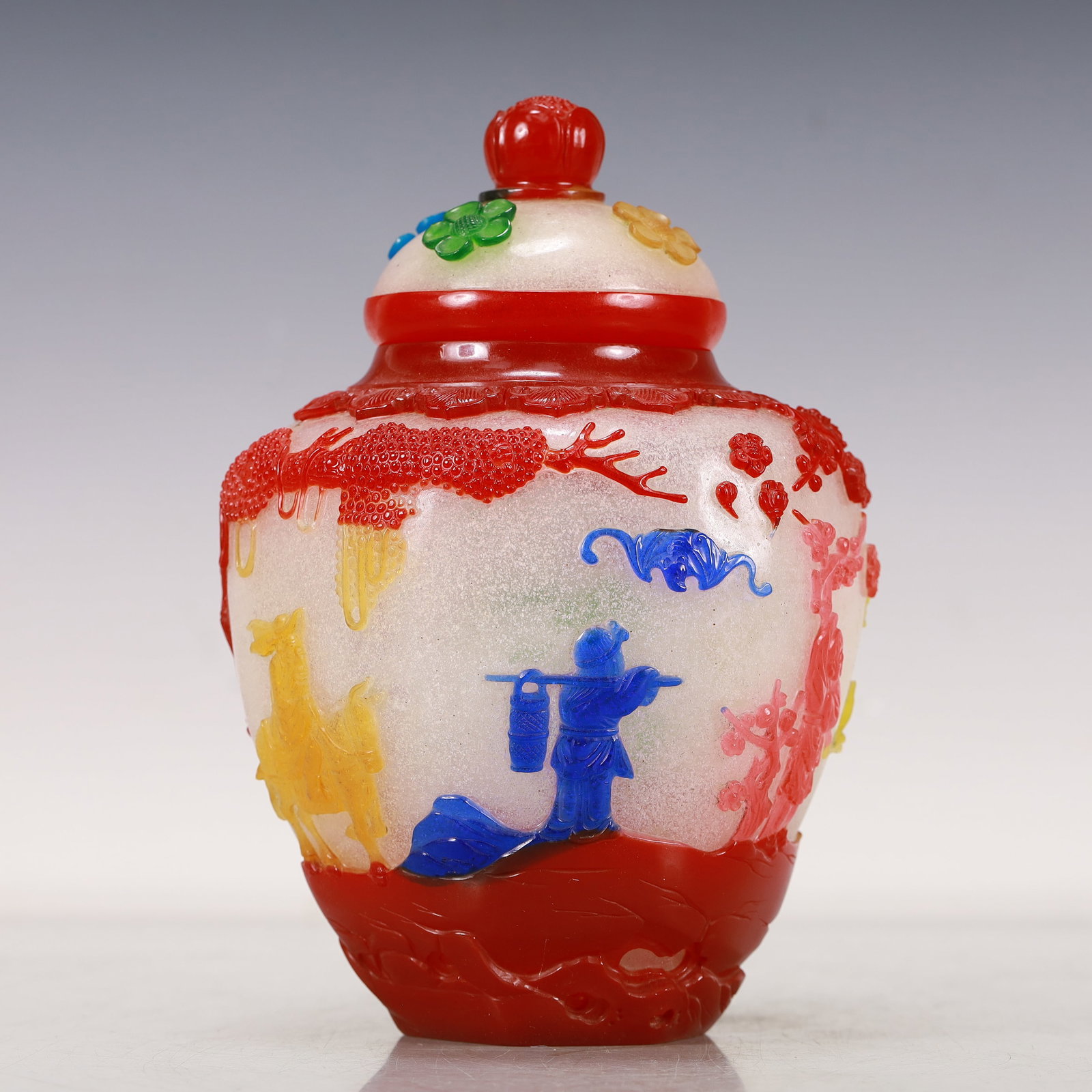 A Multi-Color Overlay White Glass 'Flower, Bird, Figure' Jar And Cover: A Multi-Color Overlay White Glass 'Flower,Bird,Figure' Jar And Cover. Enameled in polychrome with trees and a robed figure playing the flute. Chinese Qing Dynasty. Qianlong Four-Character Mark. Size:5