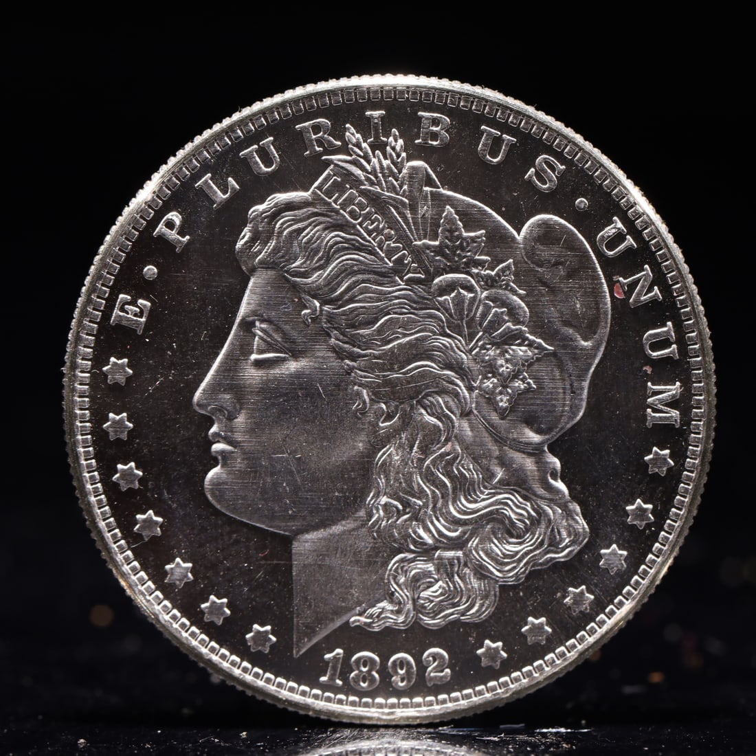 USA Morgan Dollar 1892 Coin: Obv: profile bust with date below and E PLURIBUS UNUM legend and stars around. Rev: eagle with In God we trust above within wreath with UNITED STATES OF AMERICA ONE DOLLAR legend. IN GOD WE TRUST / LI
