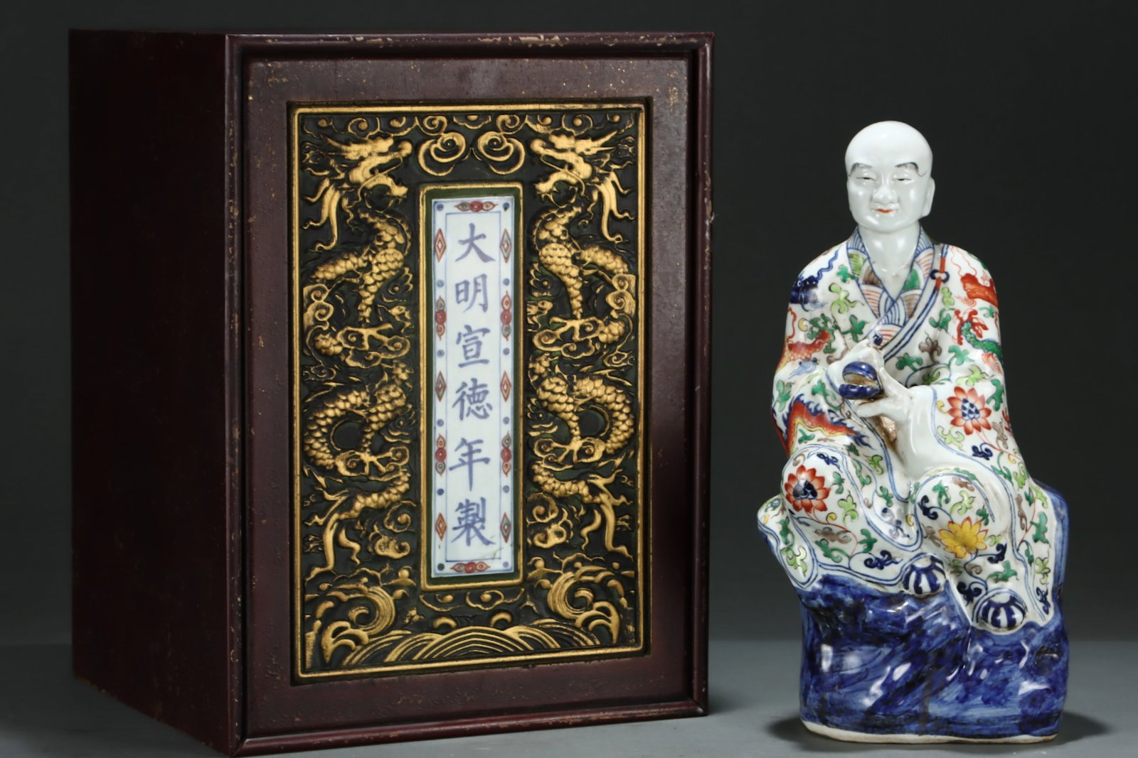 An Exquisite Wucai Lotus and Dragon Pattern Statue of Arhat: An Exquisite Wucai Lotus and Dragon Pattern Statue of Arhat,Ming Dynasty,China,Xuande Six-character Mark,Size:16.5inx8.3in 五彩缠枝莲龙纹罗汉Î