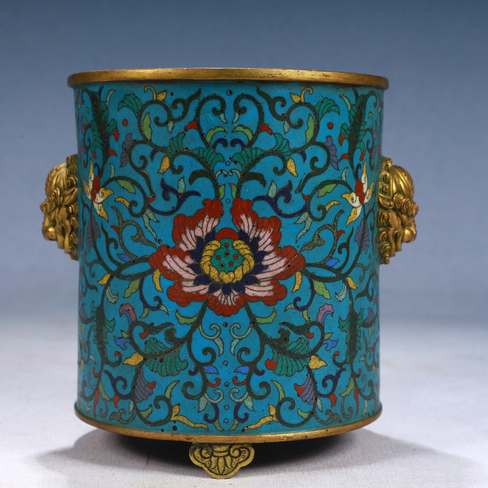 An Exquisite Cloisonne Lotus Pattern Lion-Ears and Tripod Jar: An Exquisite Cloisonne Lotus Pattern Lion-Ears and Tripod Jar,Qing Dynasty, China,Qianlong Four-character Mark,Size:4.9inx5.5in,Weight:1200g 景泰蓝缠枝莲纹
