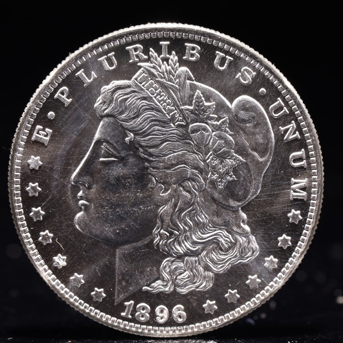 USA Morgan Dollar 1896 Coin: Obv: profile bust with date below and E PLURIBUS UNUM legend and stars around. Rev: eagle with In God we trust above within wreath with UNITED STATES OF AMERICA ONE DOLLAR legend. IN GOD WE TRUST / LI