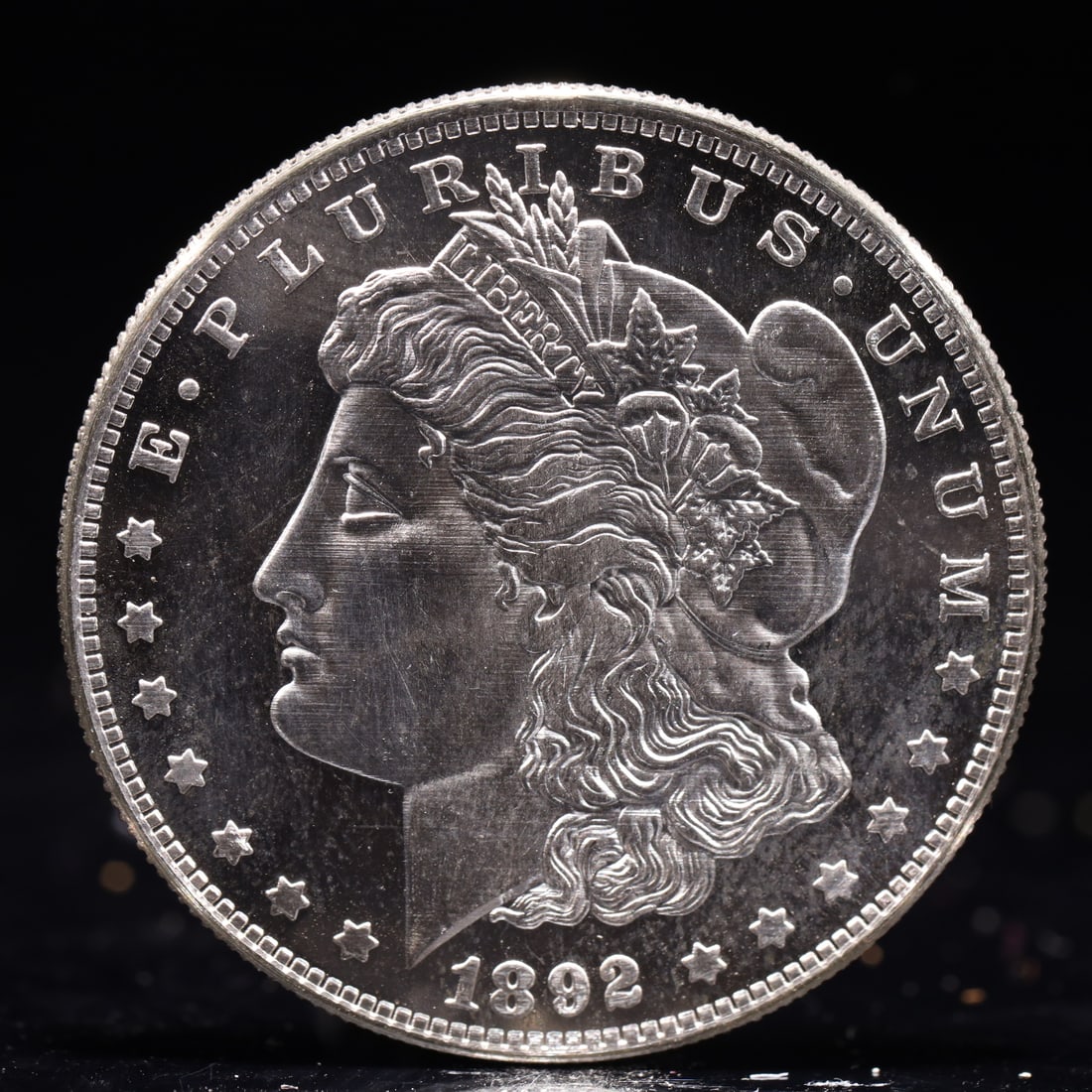 USA Morgan Dollar 1892 Coin: Obv: profile bust with date below and E PLURIBUS UNUM legend and stars around. Rev: eagle with In God we trust above within wreath with UNITED STATES OF AMERICA ONE DOLLAR legend. IN GOD WE TRUST / LI