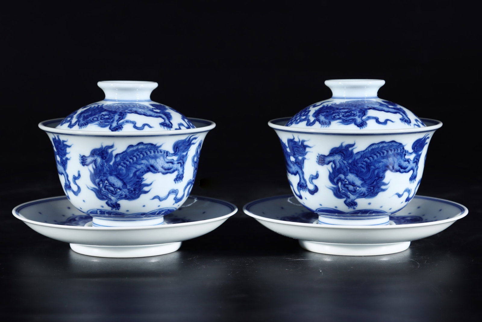 A Pair of Exquisite Blue and White Lion Pattern Bowls with Cover,with Plate: A Pair of Exquisite Blue and White Lion Pattern Bowls with Cover,with Plate,Qing Dynasty,China,Qianlong Six-character Mark,Size:3.9inx4.1in 一对青花狮子纹