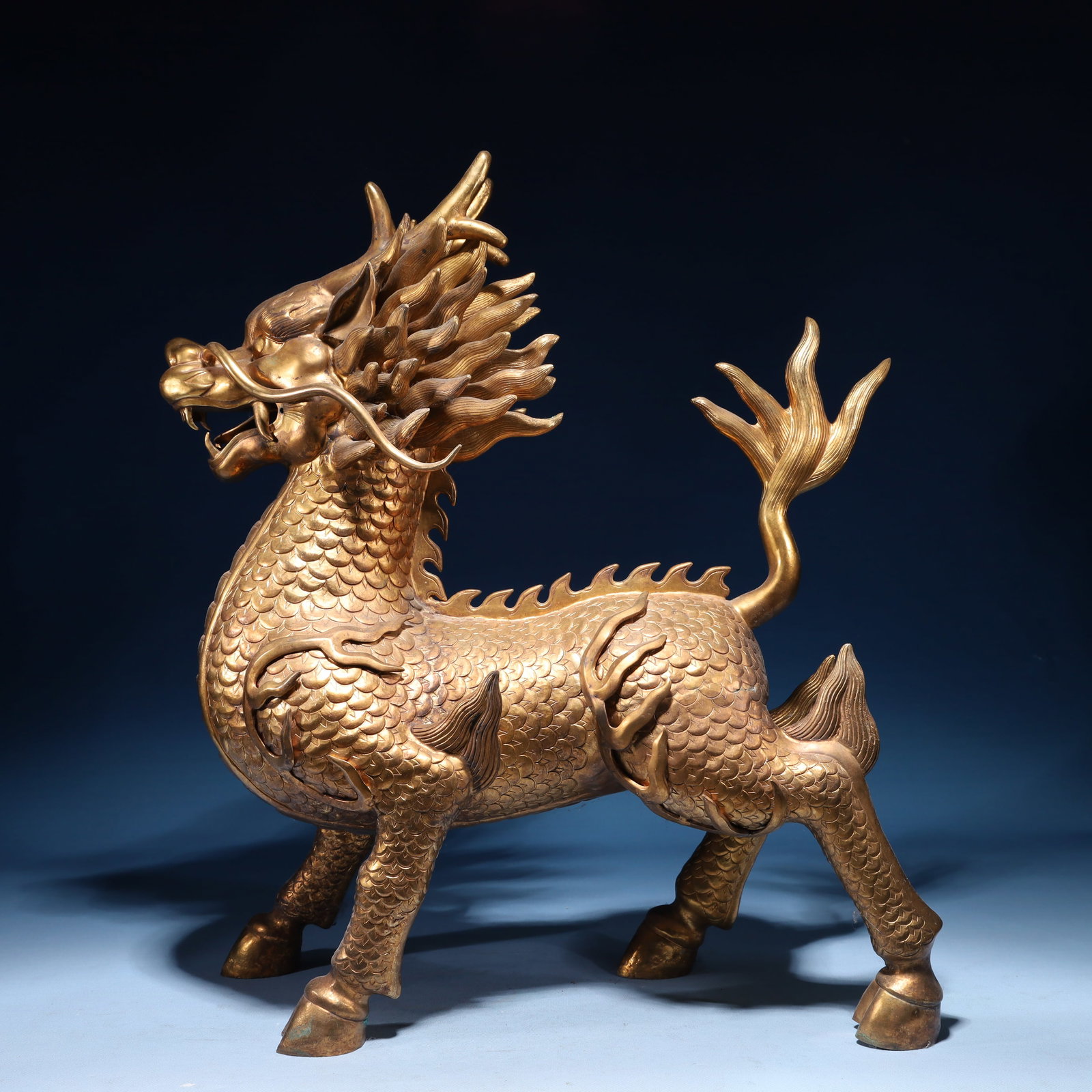 An Exquisite Gilt Bronze Kylin Ornament: An Exquisite Gilt Bronze Kylin Ornament,Qing Dynasty,China,Size:15.7inx7.1inx19.7in,Weight:15700g 铜鎏金麒麟摆件,中国清代