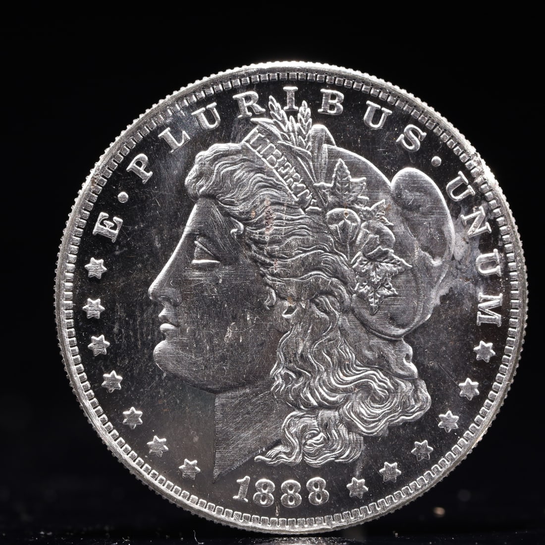 USA Morgan Dollar 1888 Coin: Obv: profile bust with date below and E PLURIBUS UNUM legend and stars around. Rev: eagle with In God we trust above within wreath with UNITED STATES OF AMERICA ONE DOLLAR legend. IN GOD WE TRUST / LI