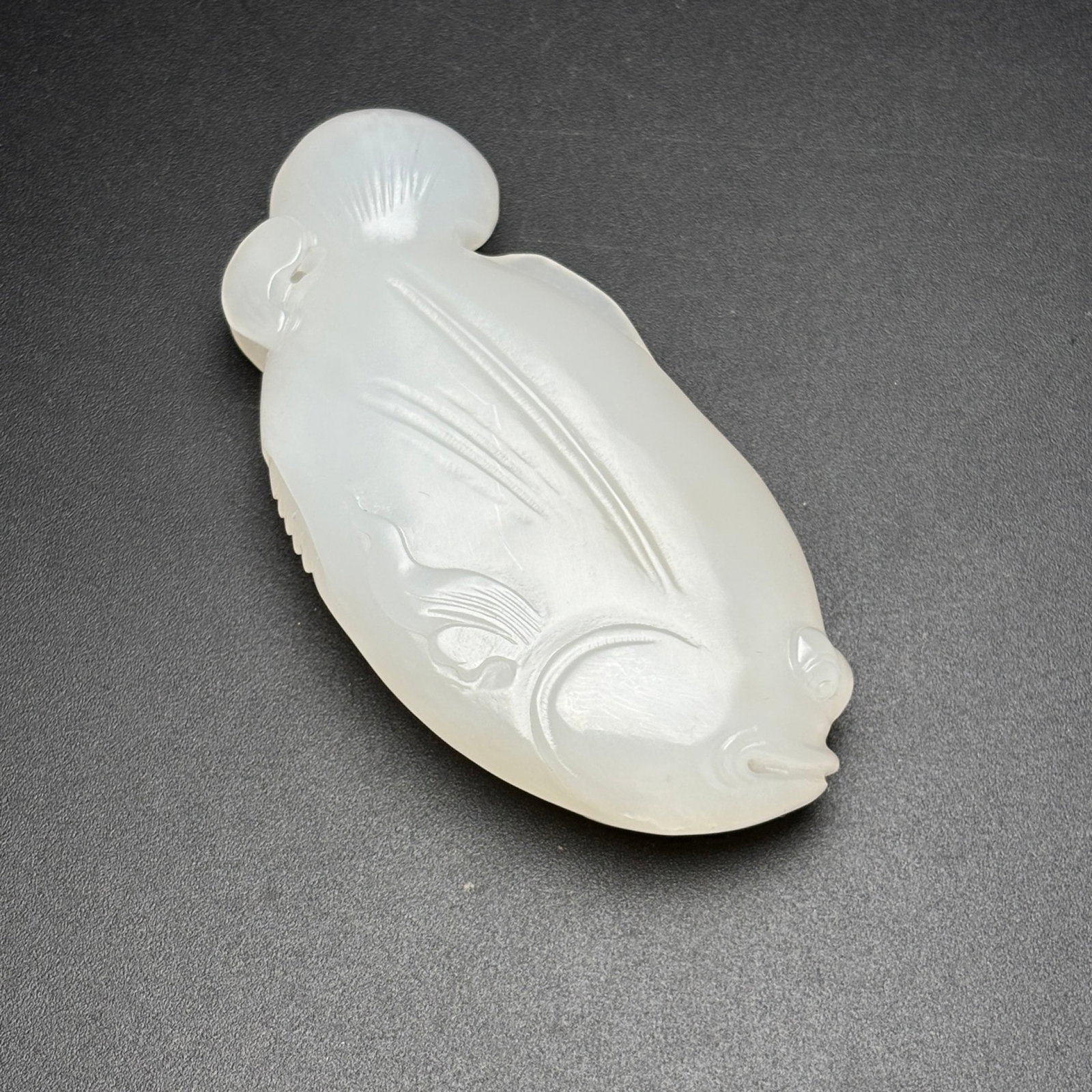 An Exquisite White Jade Fish Pendant: An Exquisite White Jade Fish Pendant,Qing Dynasty, China,Size:71mmx35mmx13mm,Weight:55g 白玉鱼挂件,中国清代