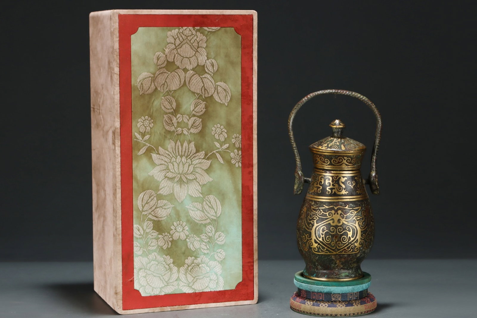 An Exquisite Bronze Inlaid Gold Beast-Face Pattern Loop-Handled Pot,with Inscription: An Exquisite Bronze Inlaid Gold Beast-Face Pattern Loop-Handled Pot,with Inscription,Size:9.8inx4.5in,Qing Dynasty,China 铜错金兽面纹提梁壶,४