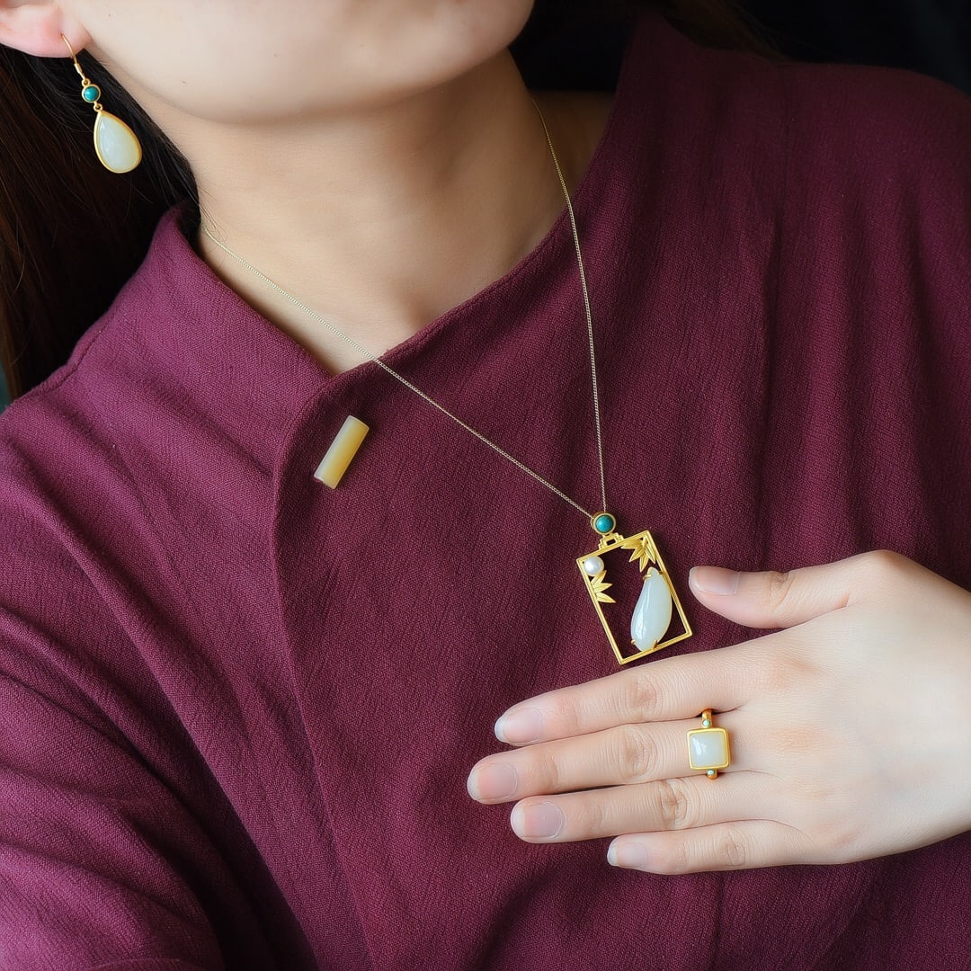 A Set of Fine Sterling Silver-Gold Plated Inlaid White Jade Jewelrys: A Set of Fine Sterling Silver-Gold Plated Inlaid White Jade Jewelrys,Size:(Earrings)10mmx18mm,(Pendant)12mmx25mm,(Ring)10mmx10mm 一套纯银镀金镶白玉