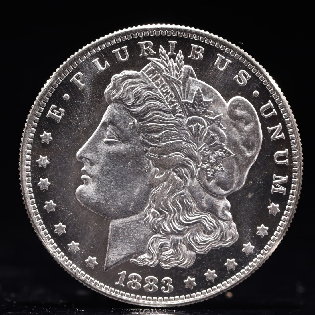 USA Morgan Dollar 1883 Coin: Obv: profile bust with date below and E PLURIBUS UNUM legend and stars around. Rev: eagle with In God we trust above within wreath with UNITED STATES OF AMERICA ONE DOLLAR legend. IN GOD WE TRUST / LI