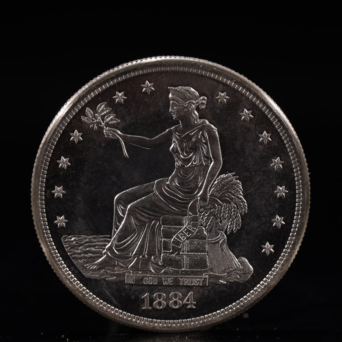 USA Trade Dollar 1884 Coin: American coin. Obverse: Liberty seated on a pedestal facing the sea to the left holding olive branches surrounded by 13 stars. IN GOD WE TRUST / LIBERTY / 1884. Reverse: An eagle holding branches