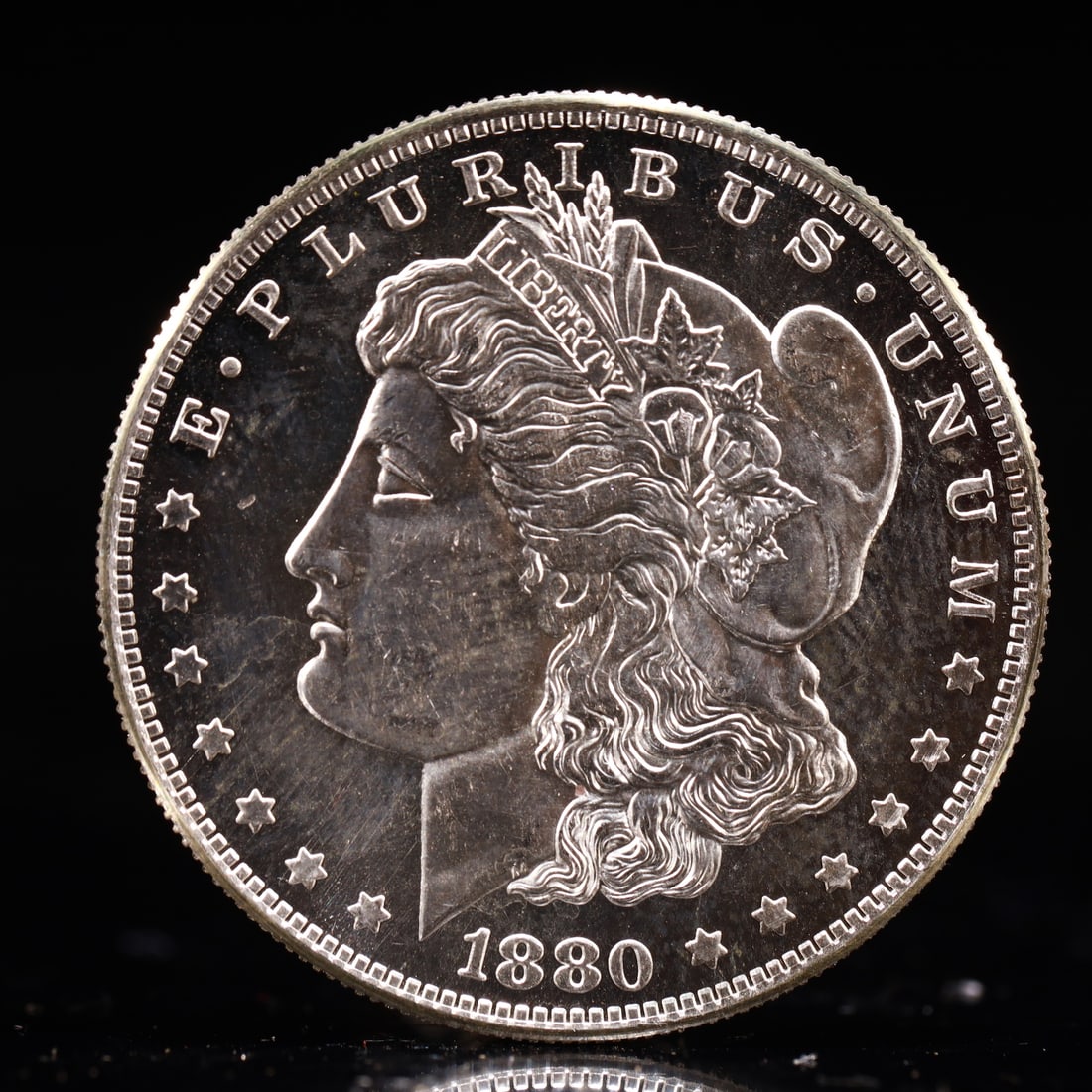 USA Morgan Dollar 1880 Coin: Obv: profile bust with date below and E PLURIBUS UNUM legend and stars around. Rev: eagle with In God we trust above within wreath with UNITED STATES OF AMERICA ONE DOLLAR legend. IN GOD WE TRUST / LI