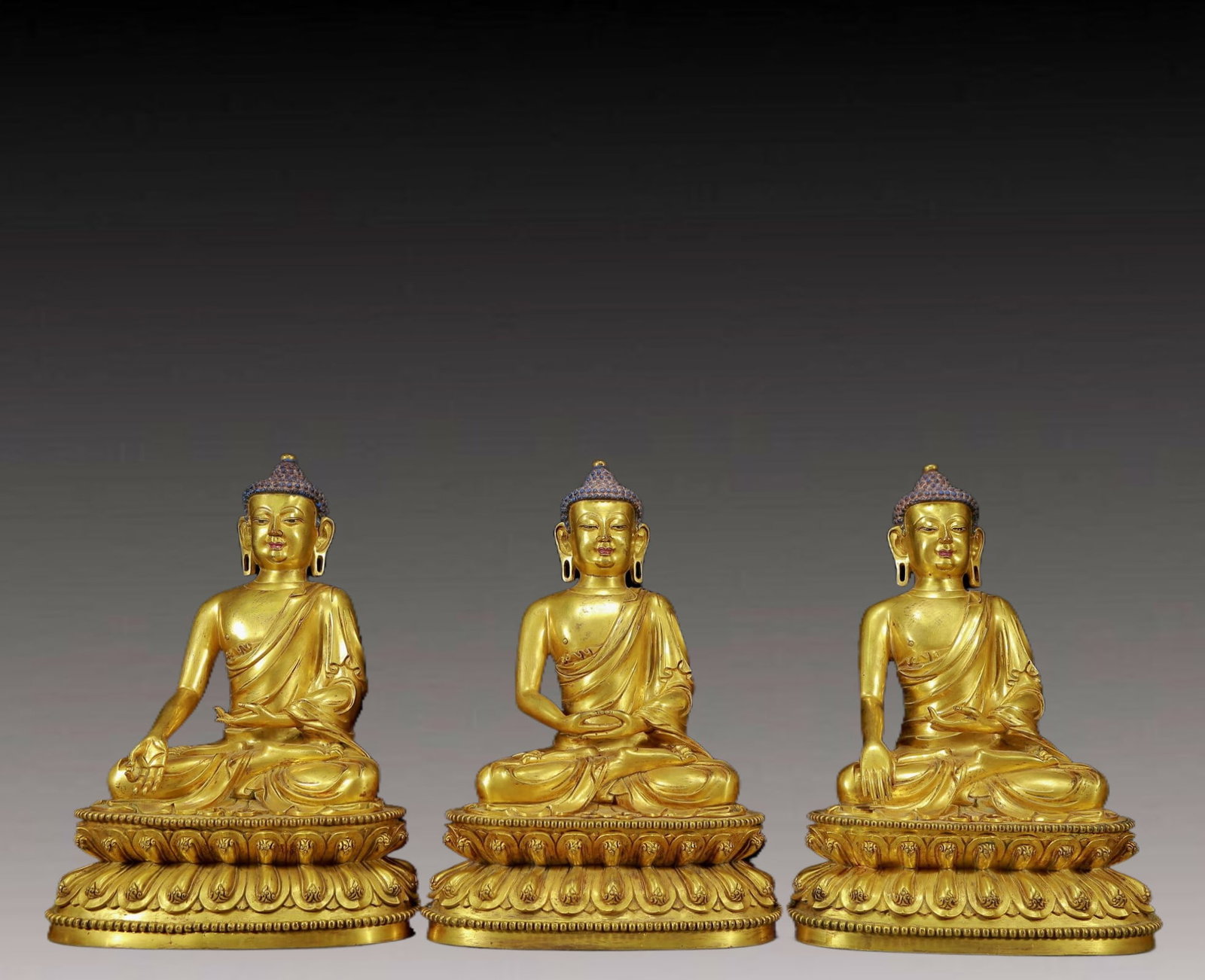 A Pair of Solemn Gilt Bronze Statue of Sakyamuni: A Pair of Solemn Gilt Bronze Statue of Sakyamuni,Ming Dynasty, China,Yongle Six-character Mark,Size:9.8inx6.7inx13.8in,Weight:18270g